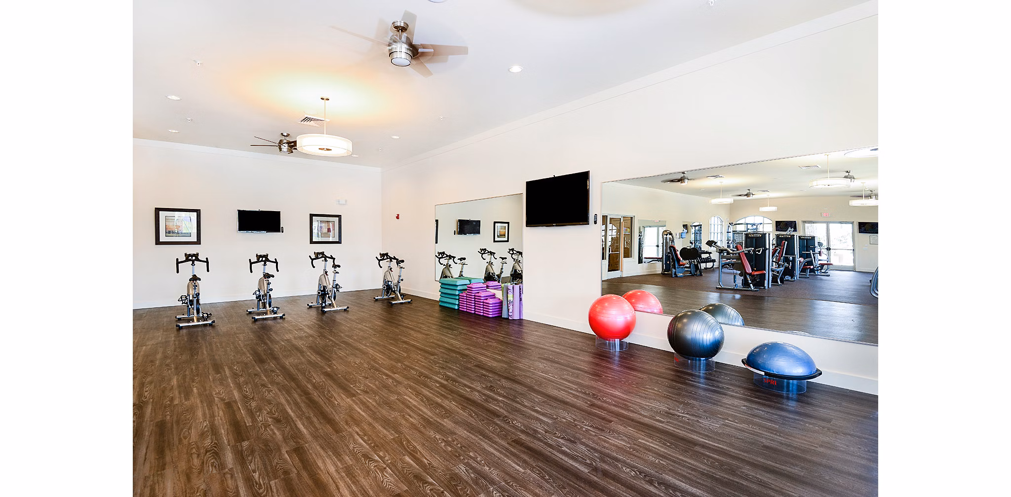 State-of-the-art fitness center at Sanctuary at West Port Apartments featuring modern equipment and workout areas