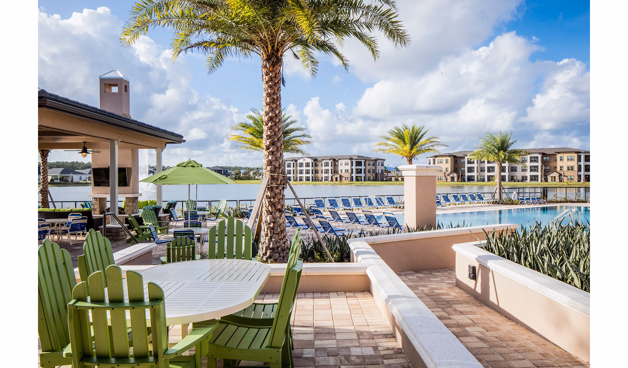 Resort-style pool surrounded by lush landscaping at Sanctuary at West Port Apartments