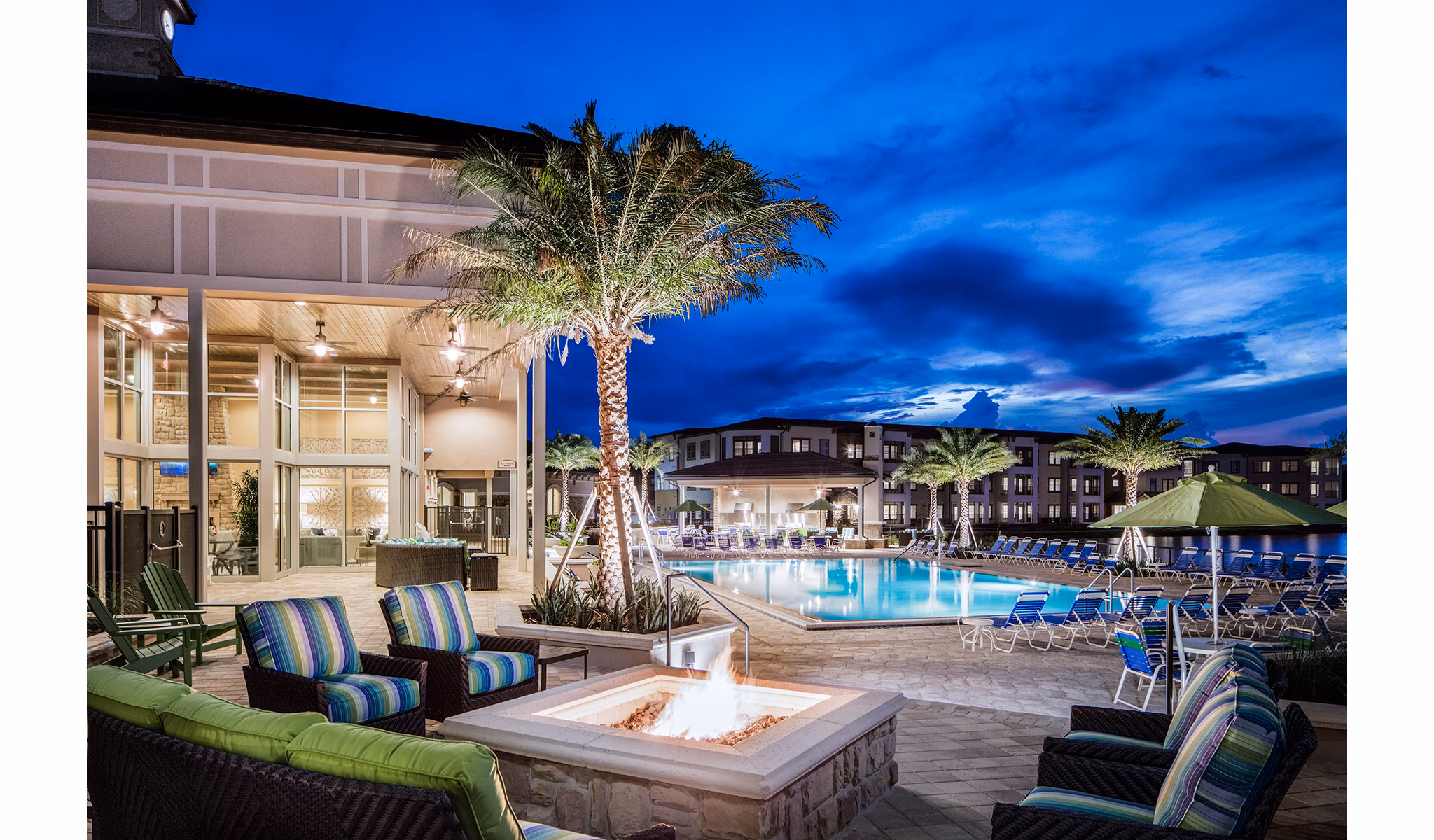 Resort-style pool with lounge seating at Sanctuary at West Port Apartments