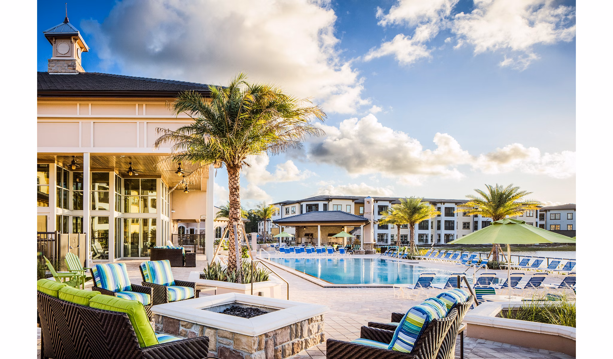 Luxurious pool with lounge chairs at Sanctuary at West Port Apartments showcasing relaxation and recreation in a serene setting