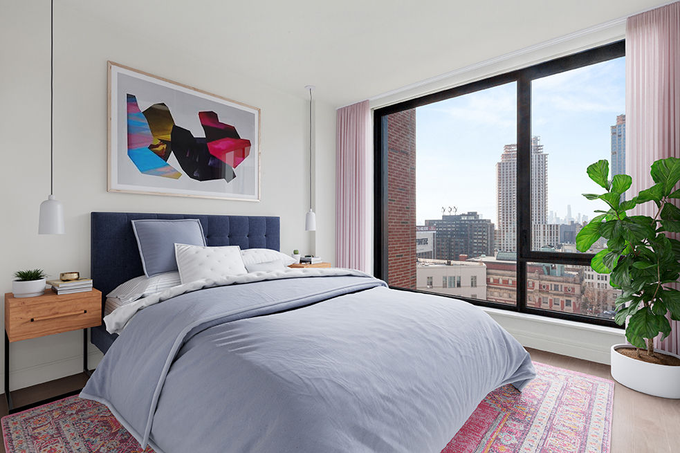 Spacious bedroom with modern decor at Watermark LIC apartments