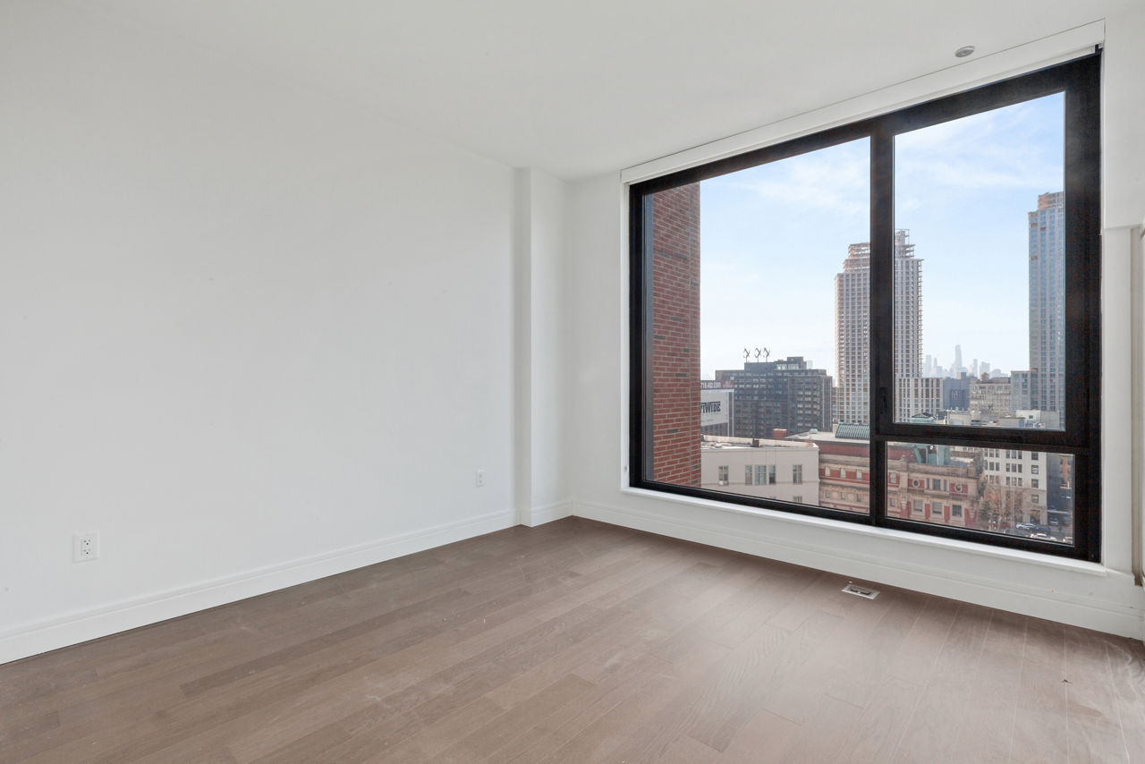 Bedroom at Watermark LIC featuring luxury design and city views, part of Greystar's premier apartments in Long Island City