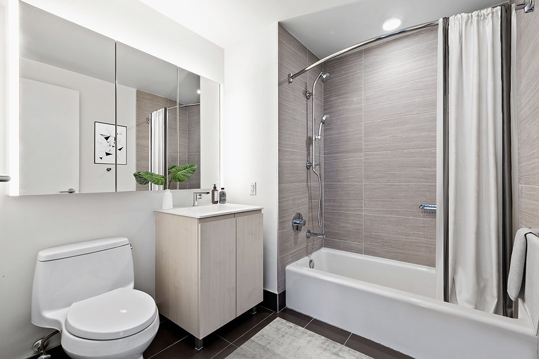 Modern bathroom with sleek fixtures at Watermark LIC apartments