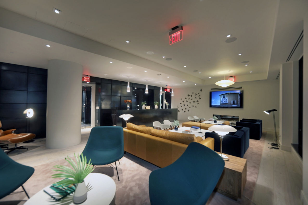 Clubhouse at Watermark LIC: Spacious clubhouse with modern decor and ample seating for gatherings in luxury apartment community