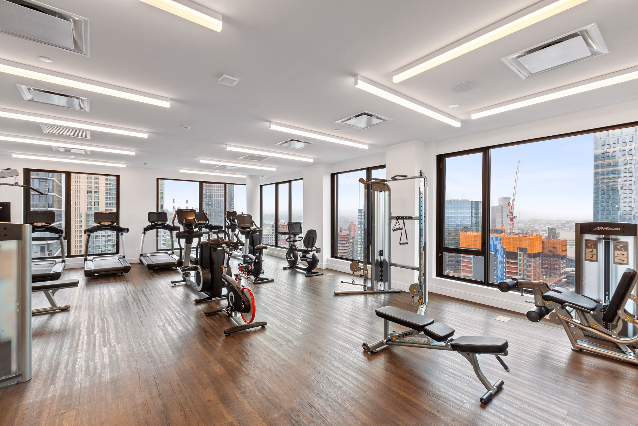 Modern fitness center featuring state-of-the-art equipment at Watermark LIC luxury apartments