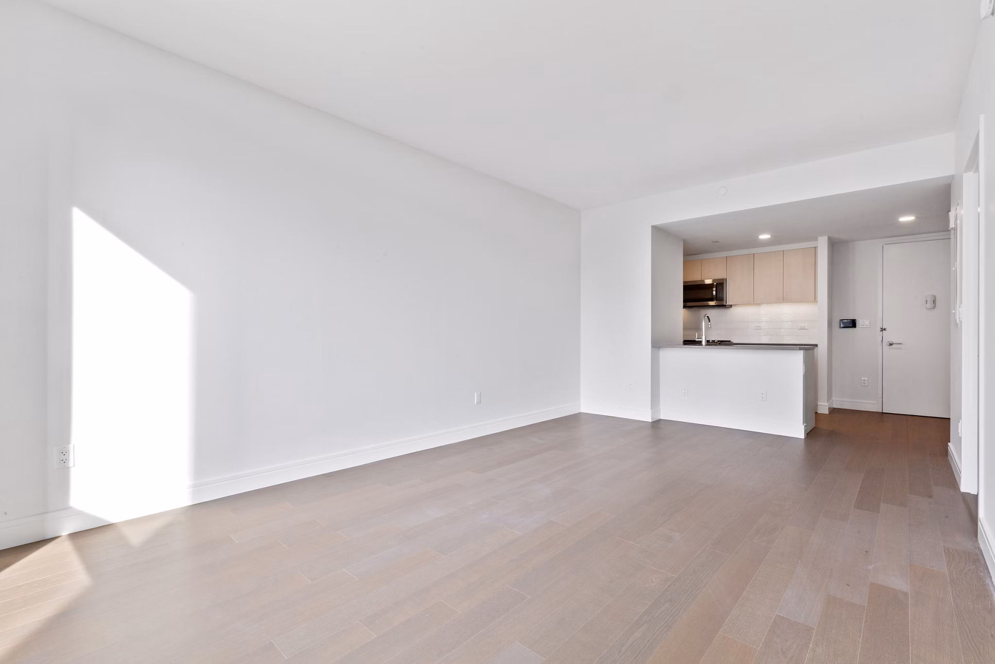 Spacious living room featuring modern decor and large windows in Watermark LIC luxury apartments
