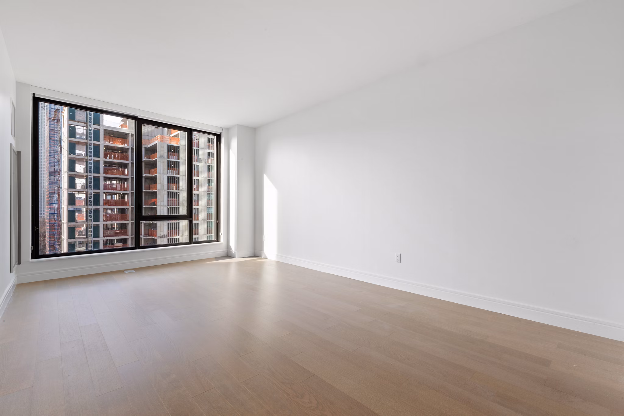 Modern living room with stylish furniture and large windows at Watermark LIC apartments
