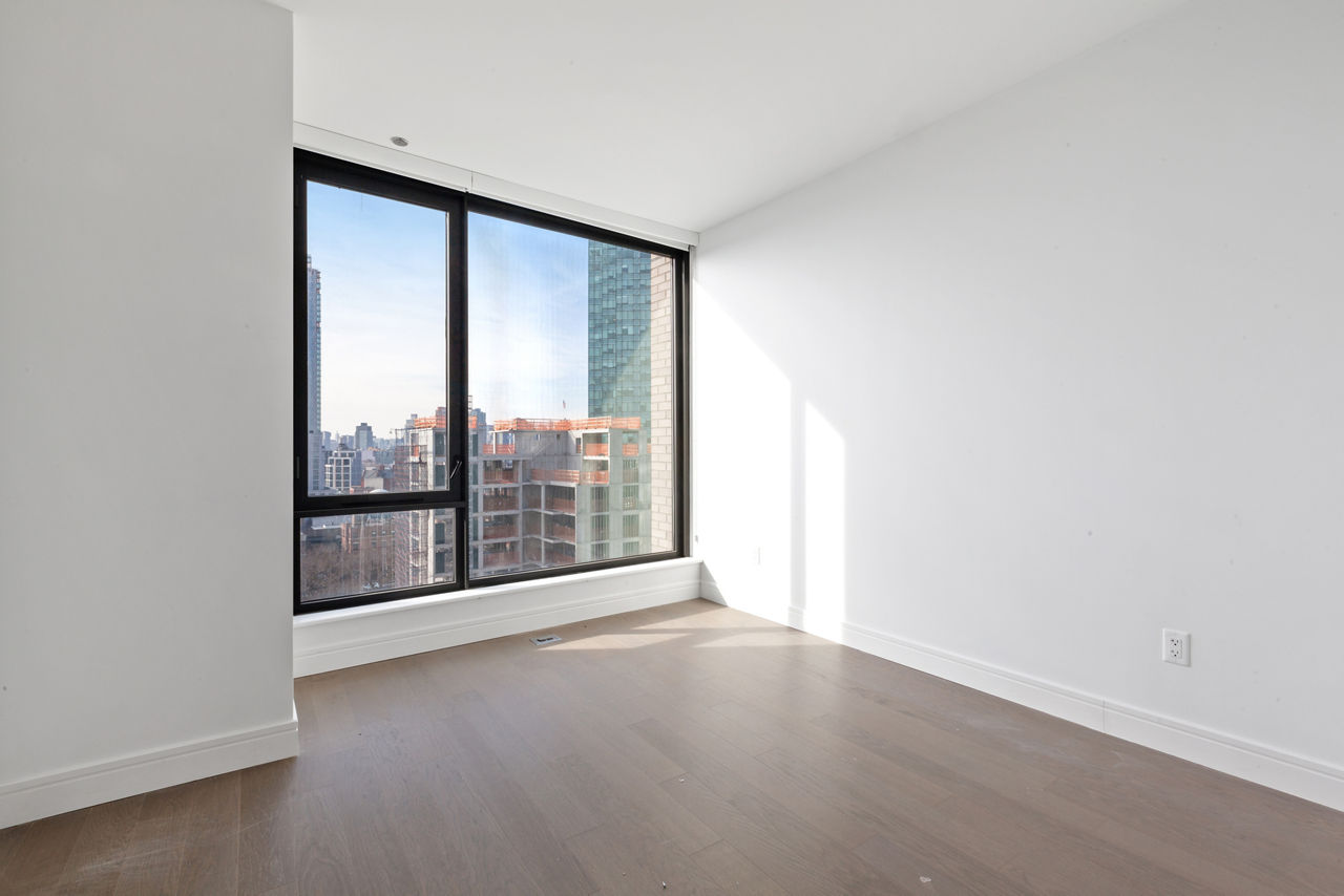 Modern living room with sleek furnishings and city views at Watermark LIC apartments