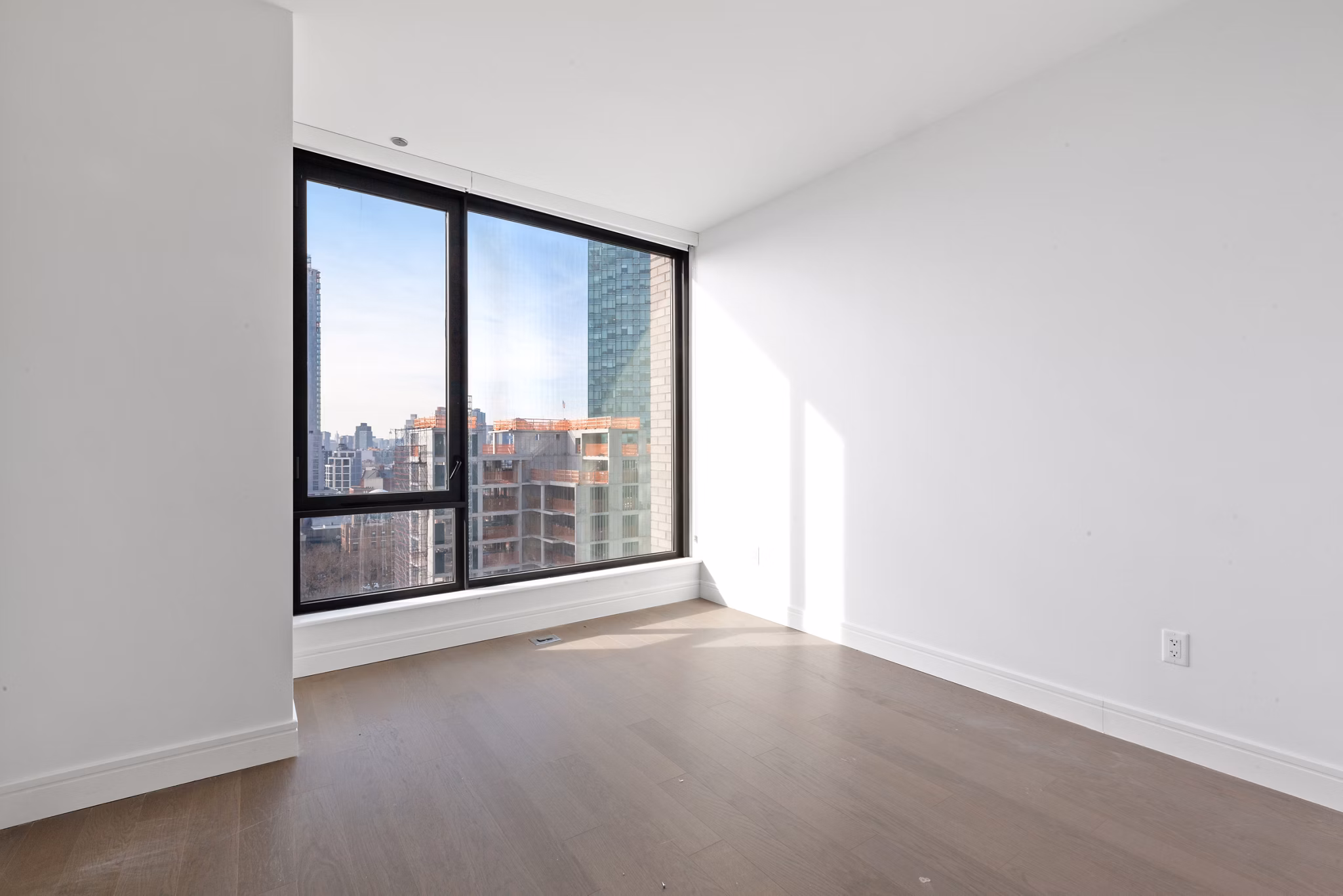 Modern living room with sleek furnishings and city views at Watermark LIC apartments