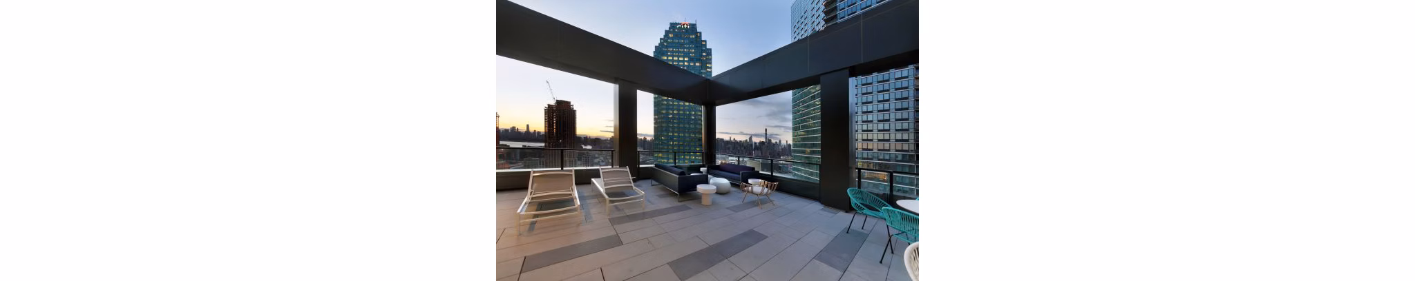 Patio with contemporary seating and greenery at Watermark LIC, luxury apartments