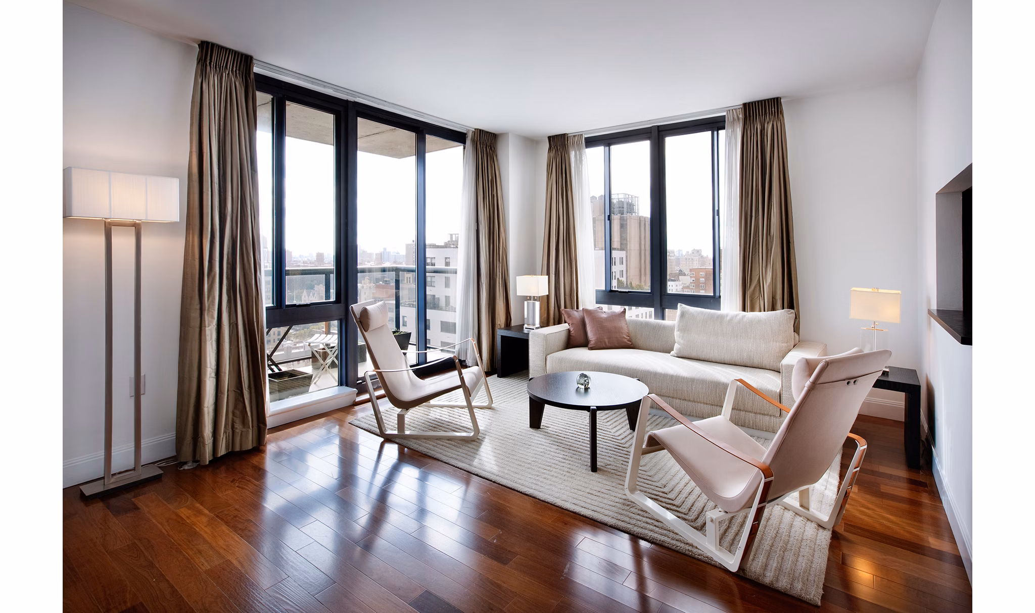 Spacious living room with modern decor at INSTRATA Gramercy Apartments