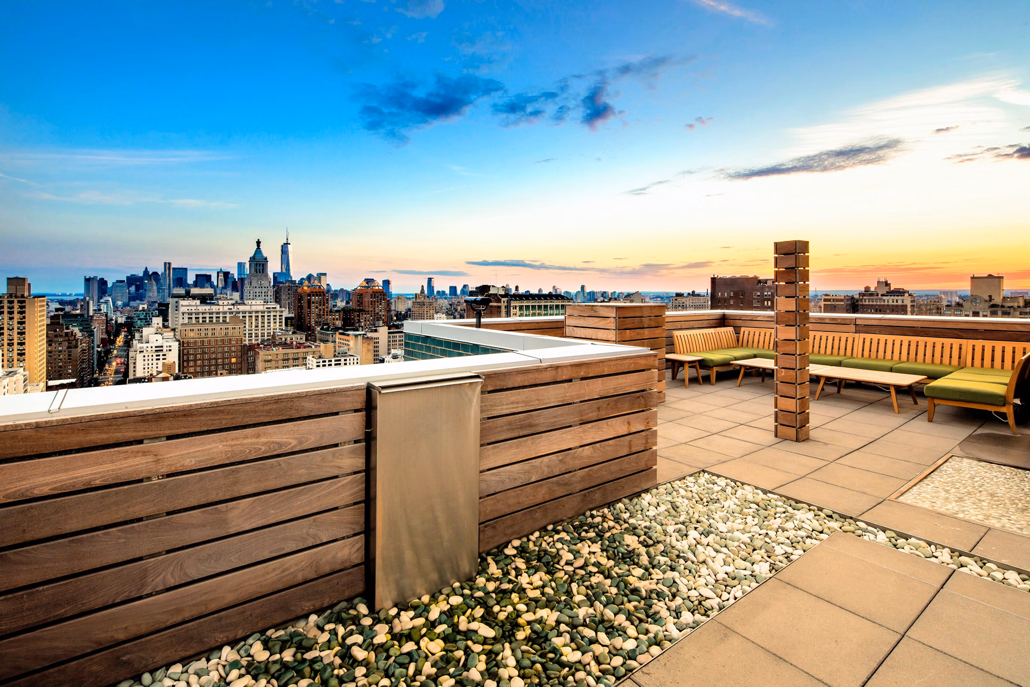 Patio with modern seating and lush greenery at INSTRATA Gramercy Apartments