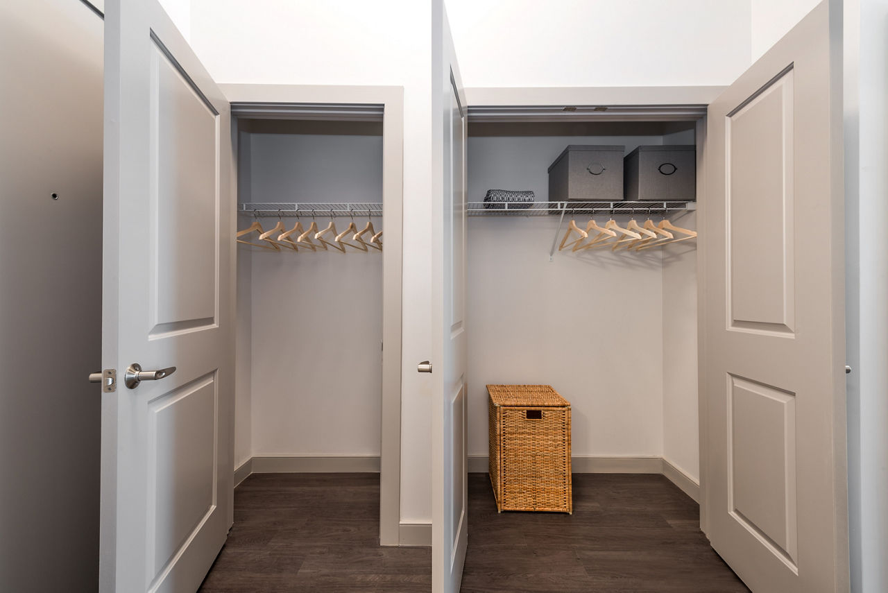 Spacious walk-in closet featuring organized hangers and storage solutions in luxury apartments