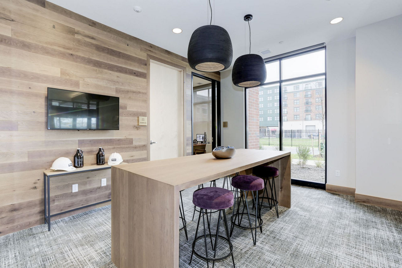 Clubhouse featuring contemporary design and ample seating at Porter Street Apartments
