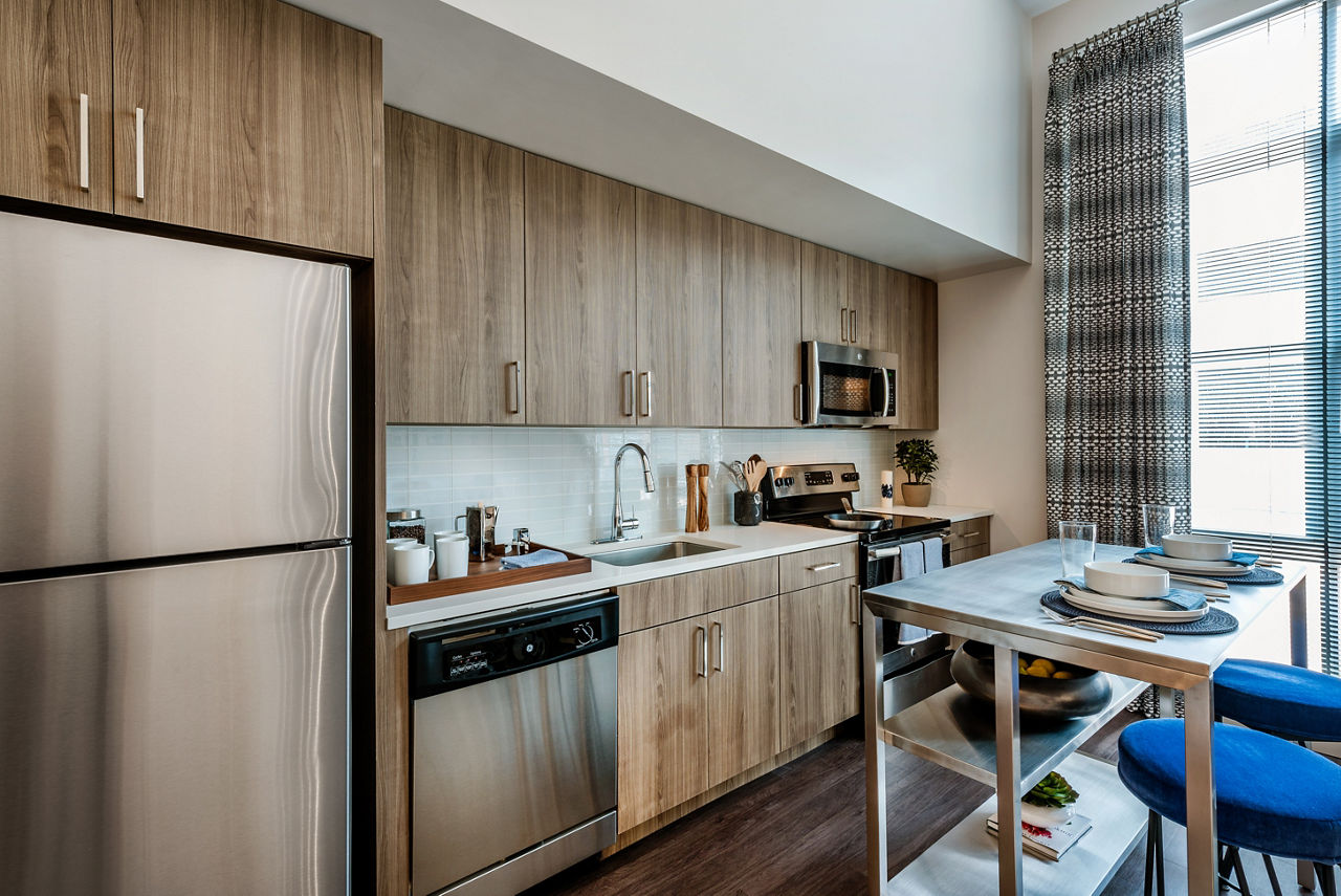 Modern kitchen with stainless steel appliances in Greystar luxury apartments