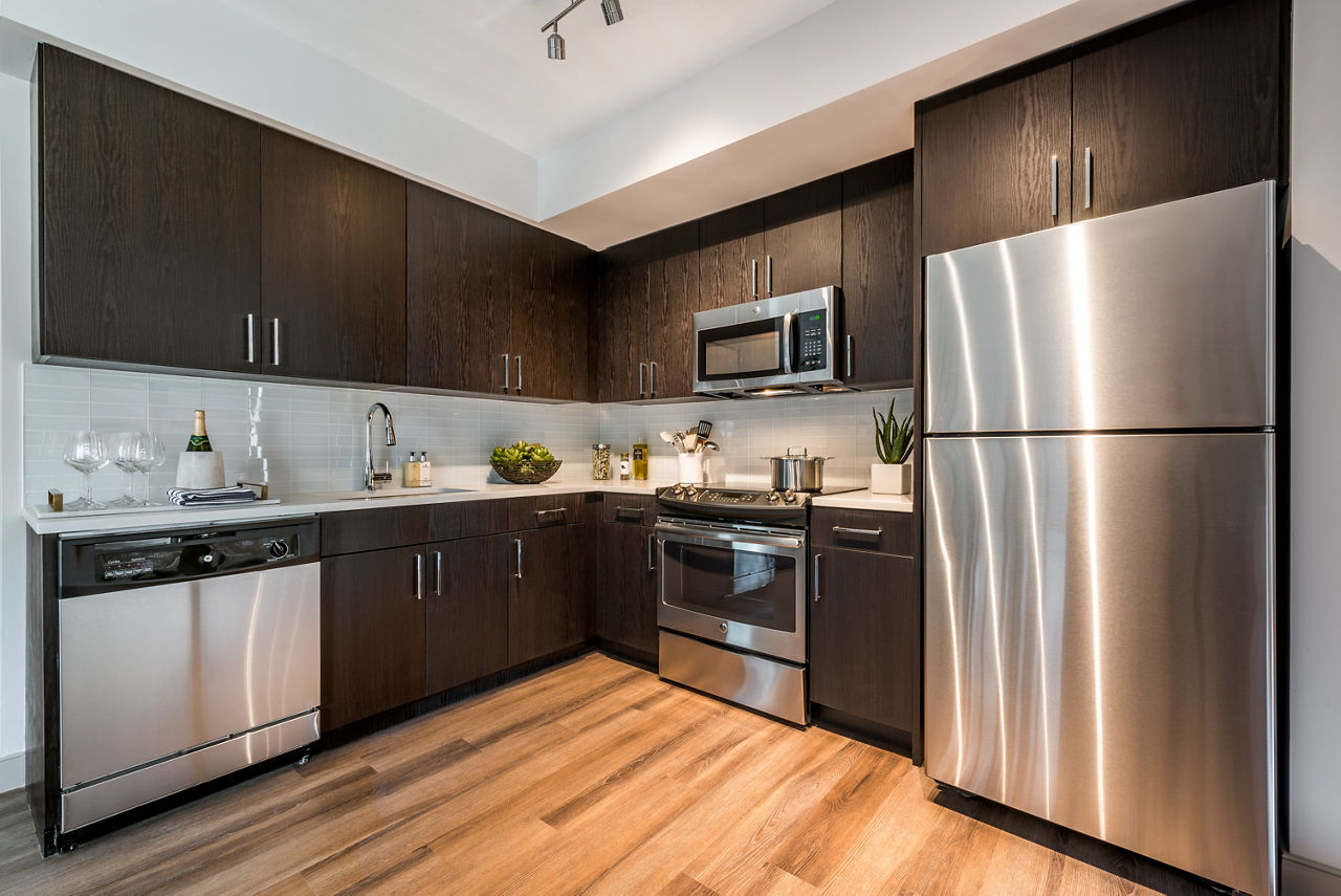 Modern kitchen with stainless steel appliances in Greystar luxury apartments