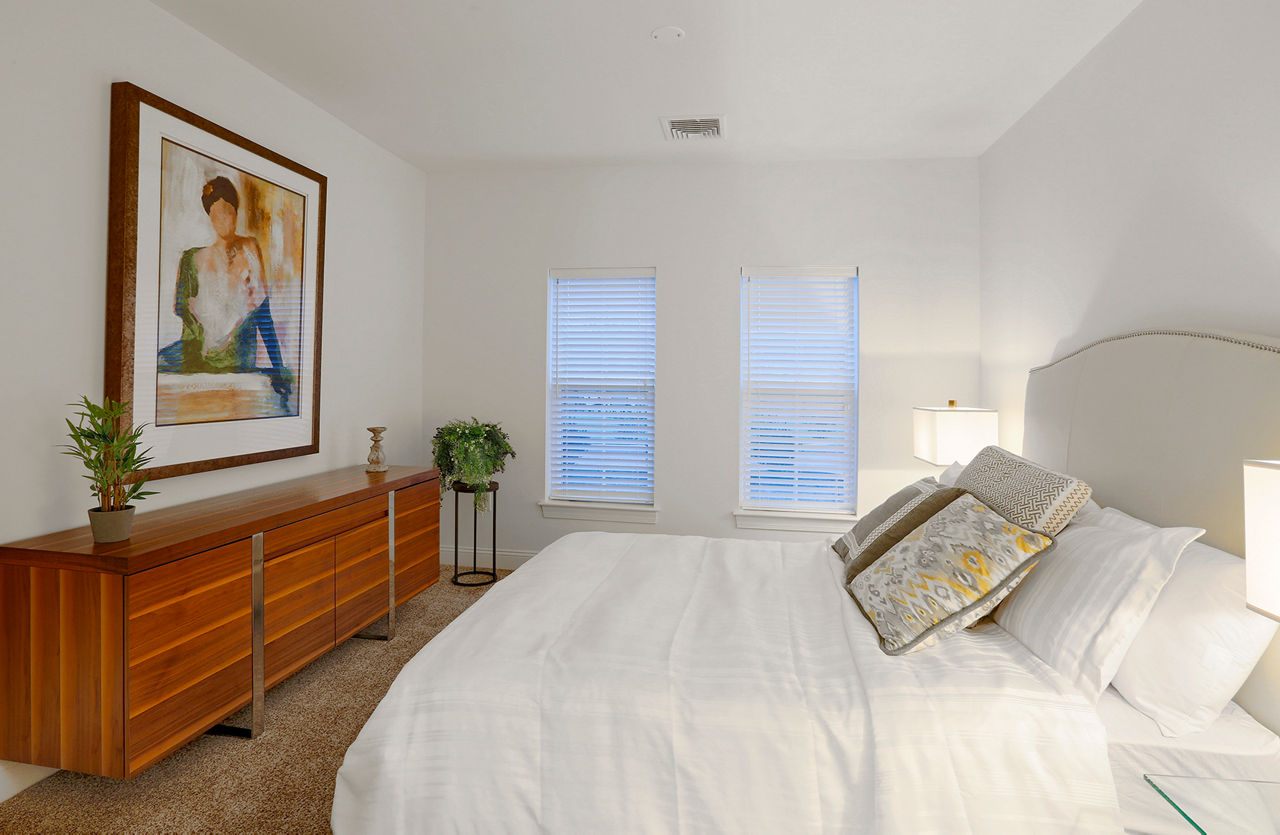 Cozy bedroom with modern decor at The Shipyard at Port Jefferson Harbor Apartments