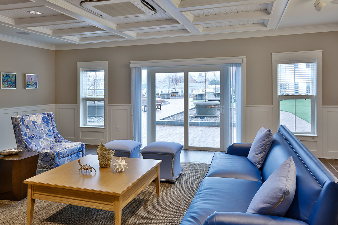 Clubhouse with comfortable seating and modern decor at The Shipyard at Port Jefferson Harbor Apartments