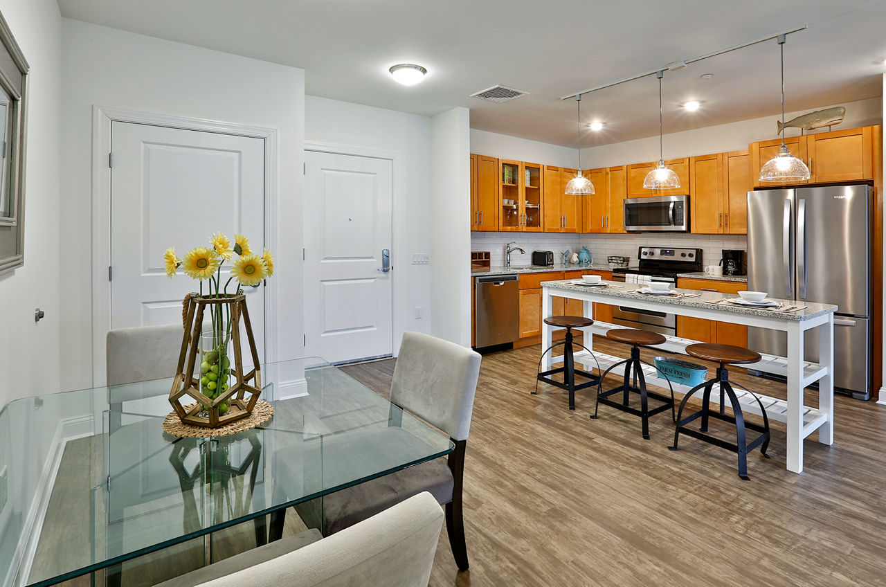 Modern kitchen with stainless steel appliances at The Shipyard at Port Jefferson Harbor Apartments