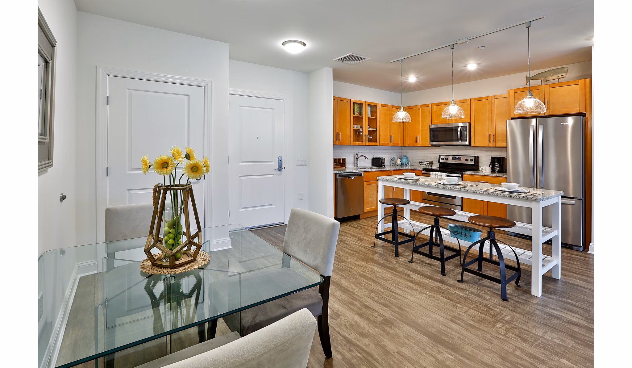 Modern kitchen with stainless steel appliances at The Shipyard at Port Jefferson Harbor Apartments