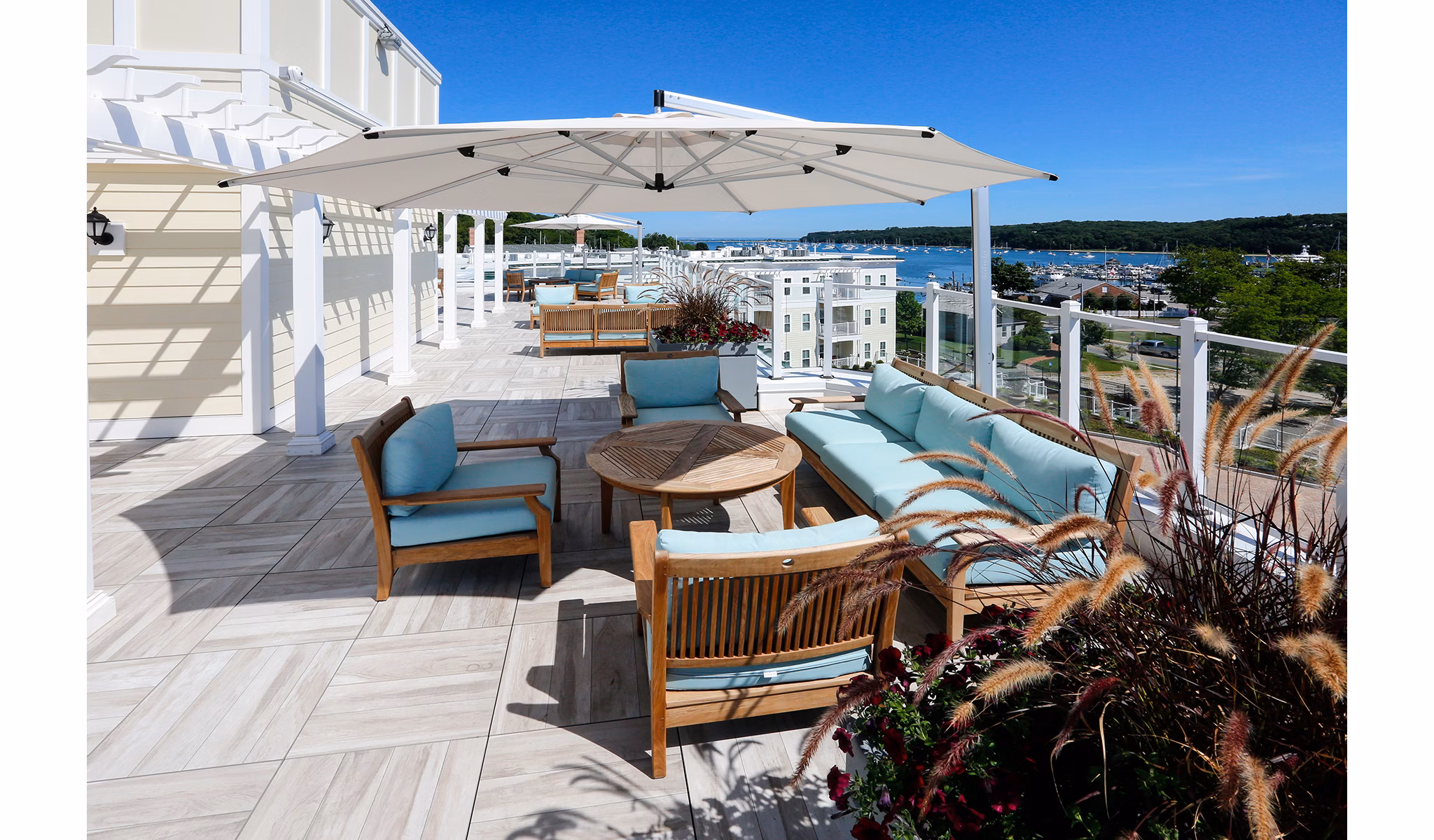 Elevated patio with harbor views at The Shipyard at Port Jefferson Harbor Apartments