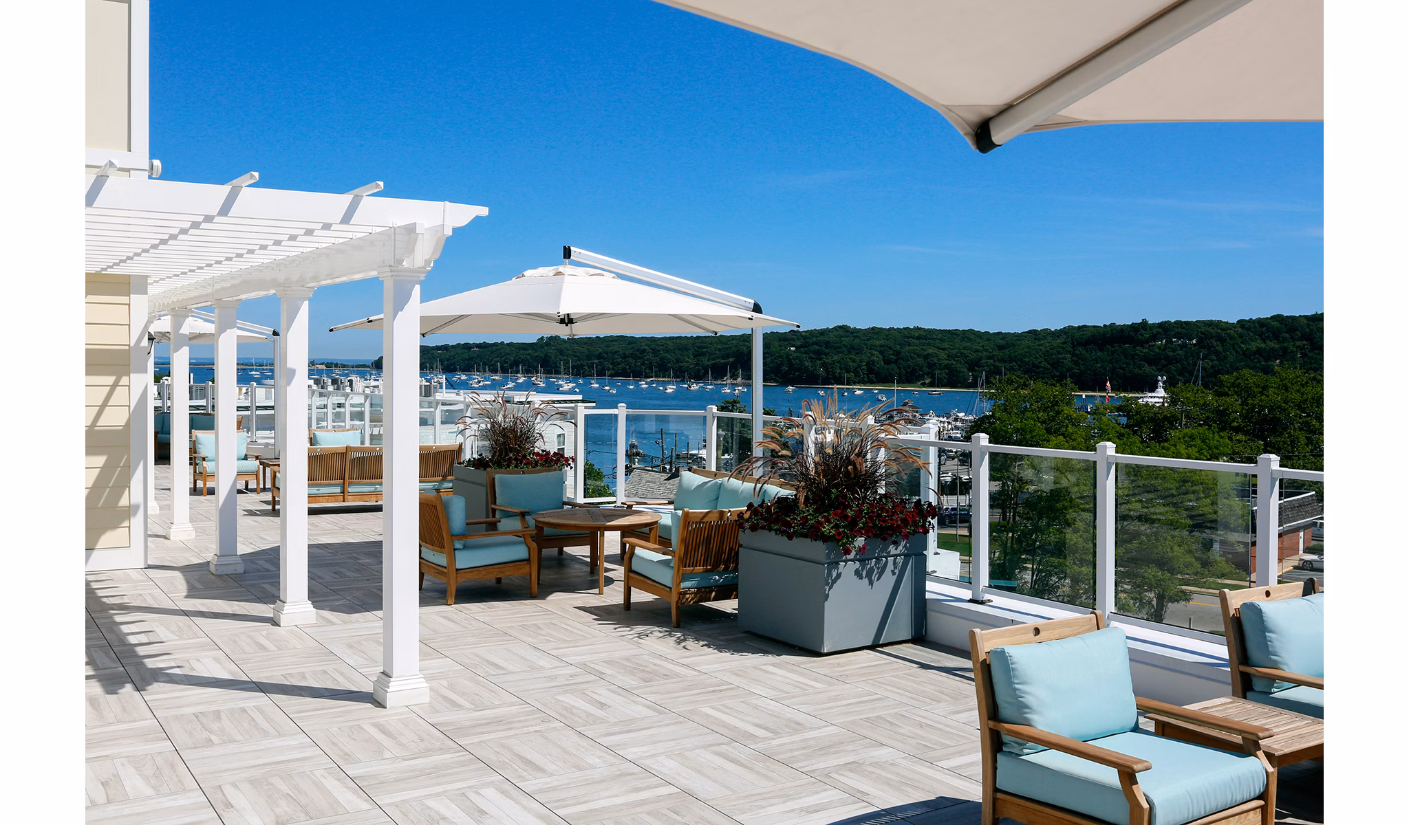 Private patio with scenic harbor views at The Shipyard at Port Jefferson Harbor Apartments