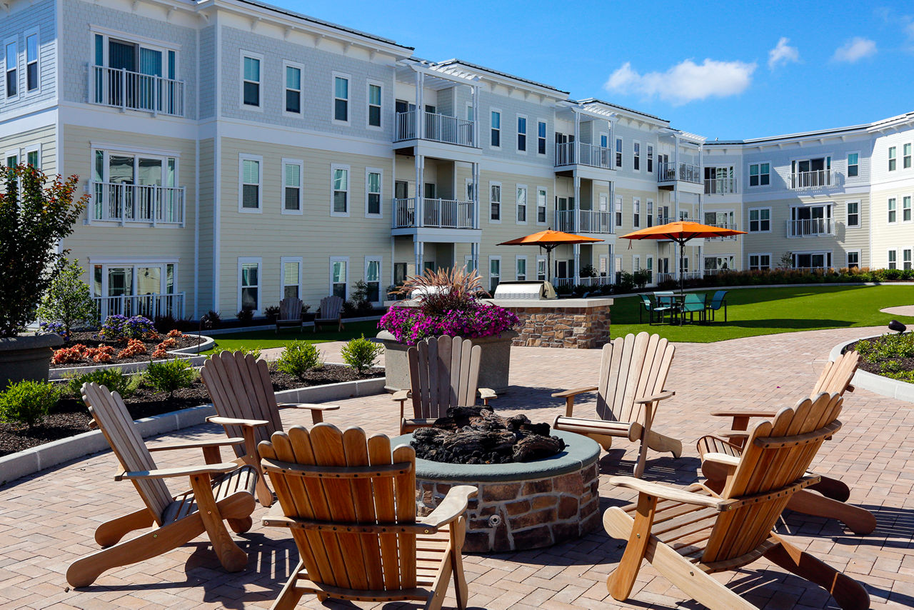 Cozy fire pit at The Shipyard at Port Jefferson Harbor Apartments, ideal for social gatherings and relaxing evenings