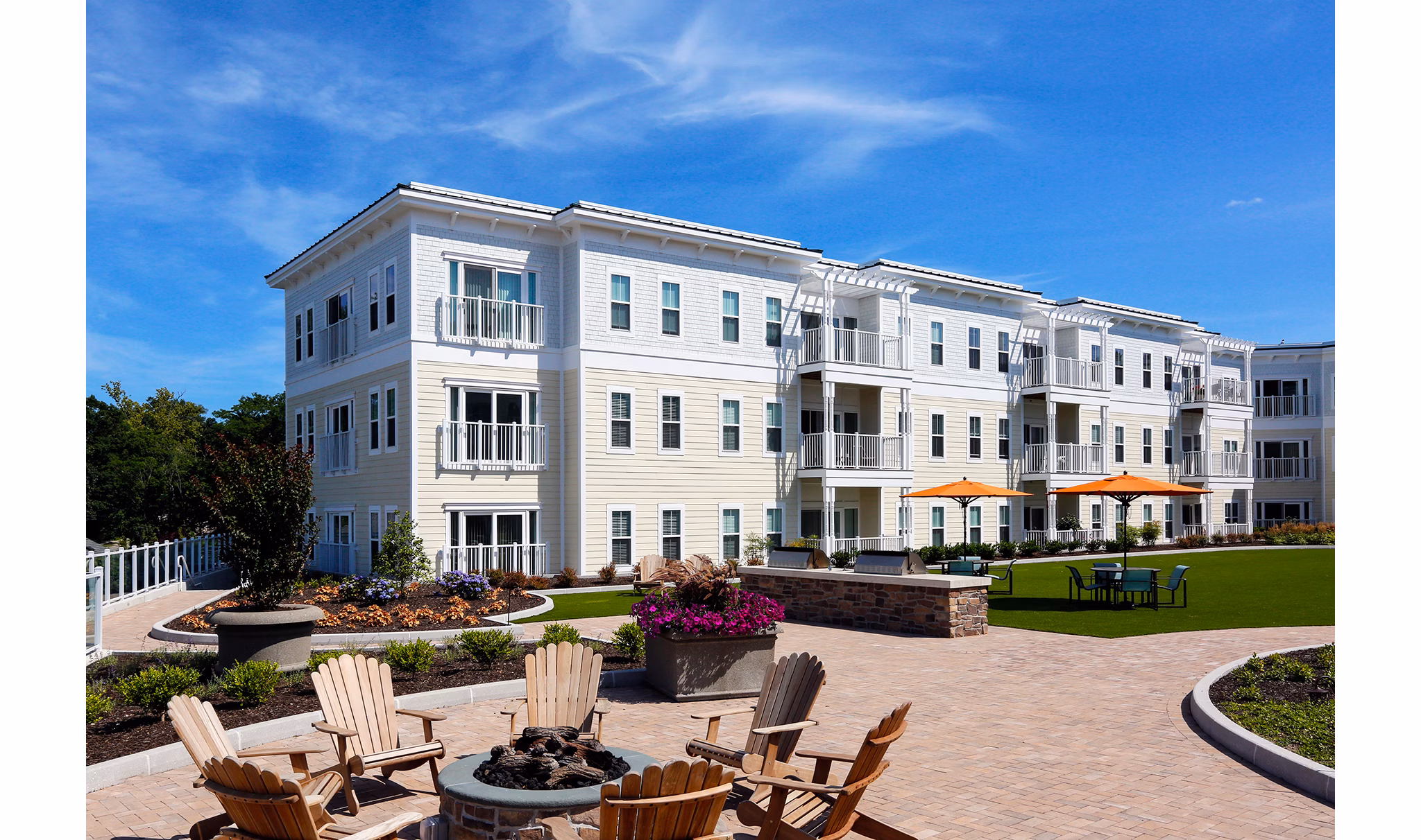 Cozy fire pit area at The Shipyard at Port Jefferson Harbor Apartments, ideal for social gatherings and relaxation