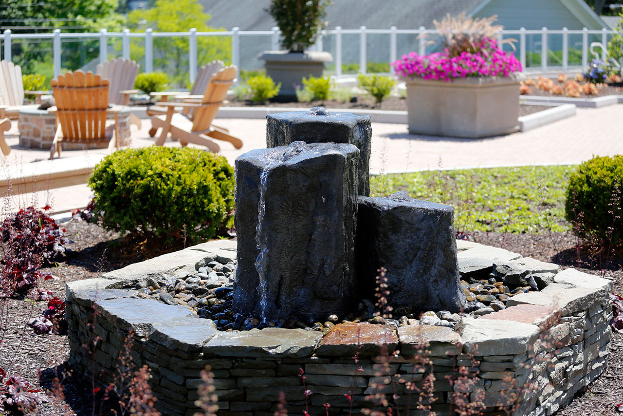 Courtyard with modern landscaping at The Shipyard at Port Jefferson Harbor Apartments