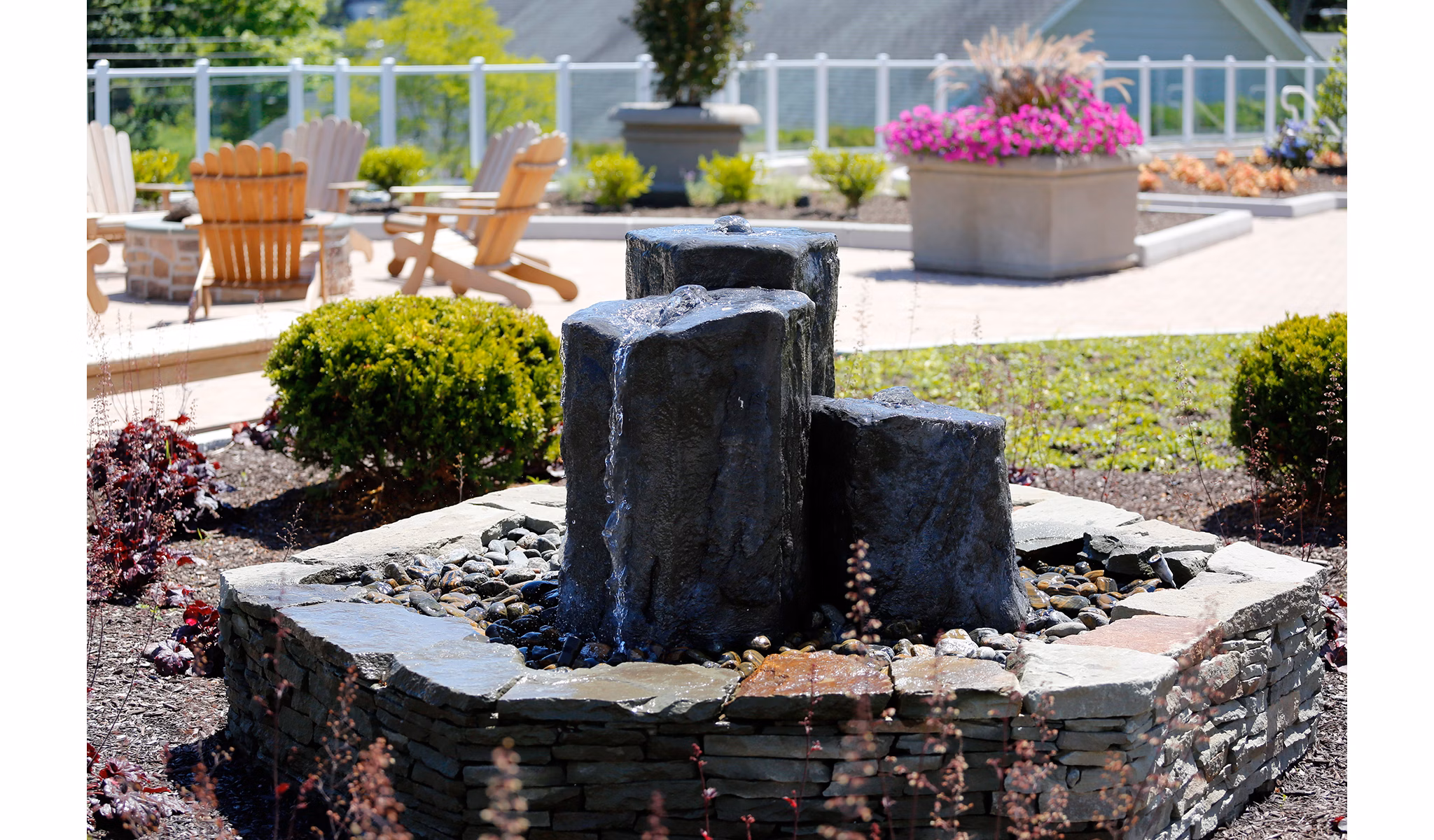 Courtyard with modern landscaping at The Shipyard at Port Jefferson Harbor Apartments