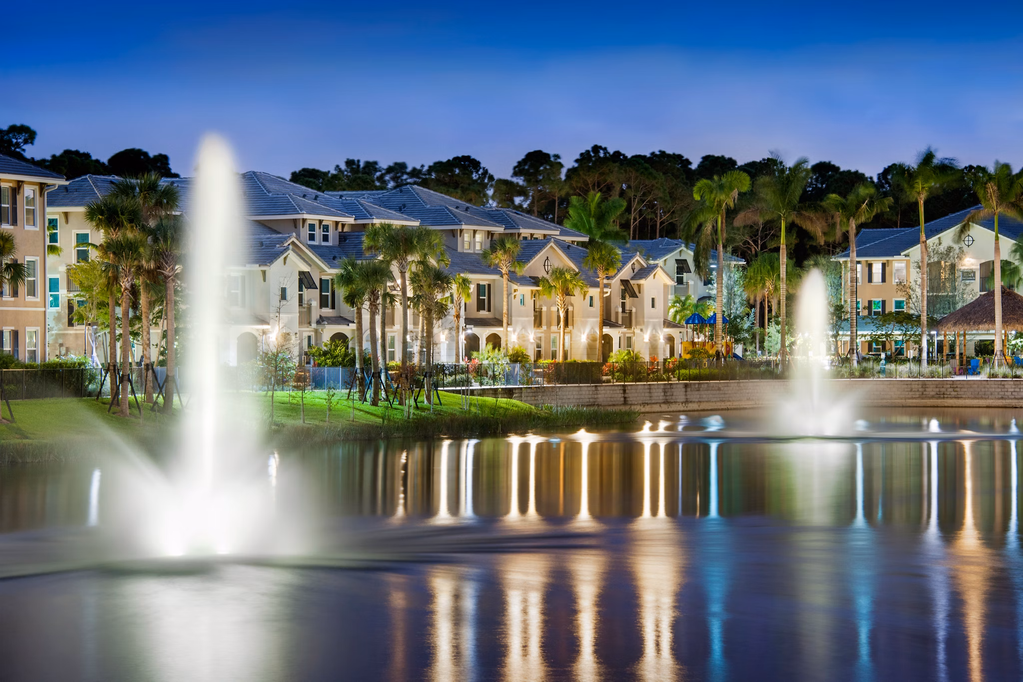 The Quaye at Palm Beach Gardens: Luxury apartment exteriors with lush landscaping and modern design