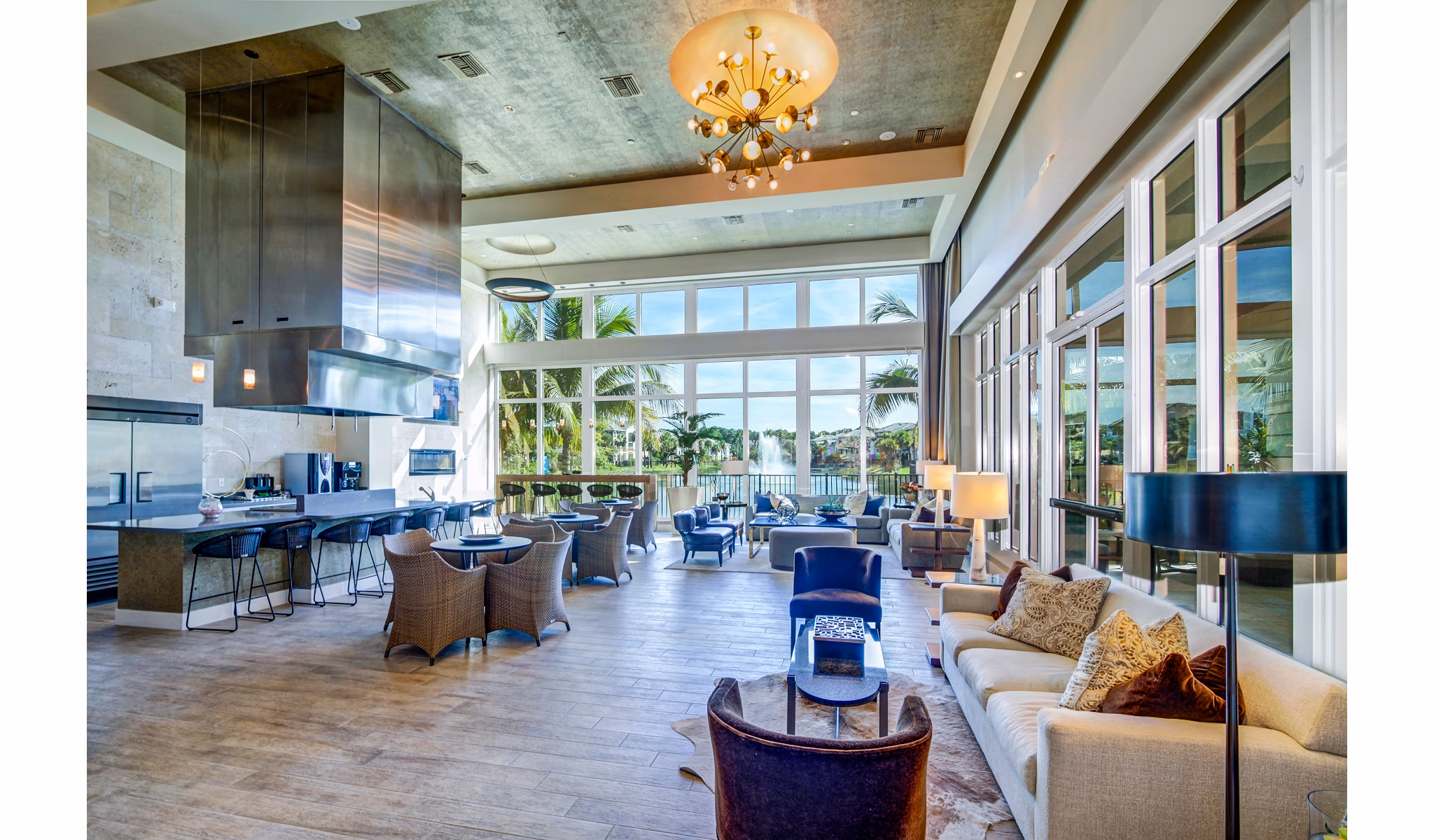 Elegant clubhouse decorated with modern furnishings at The Quaye at Palm Beach Gardens Apartments