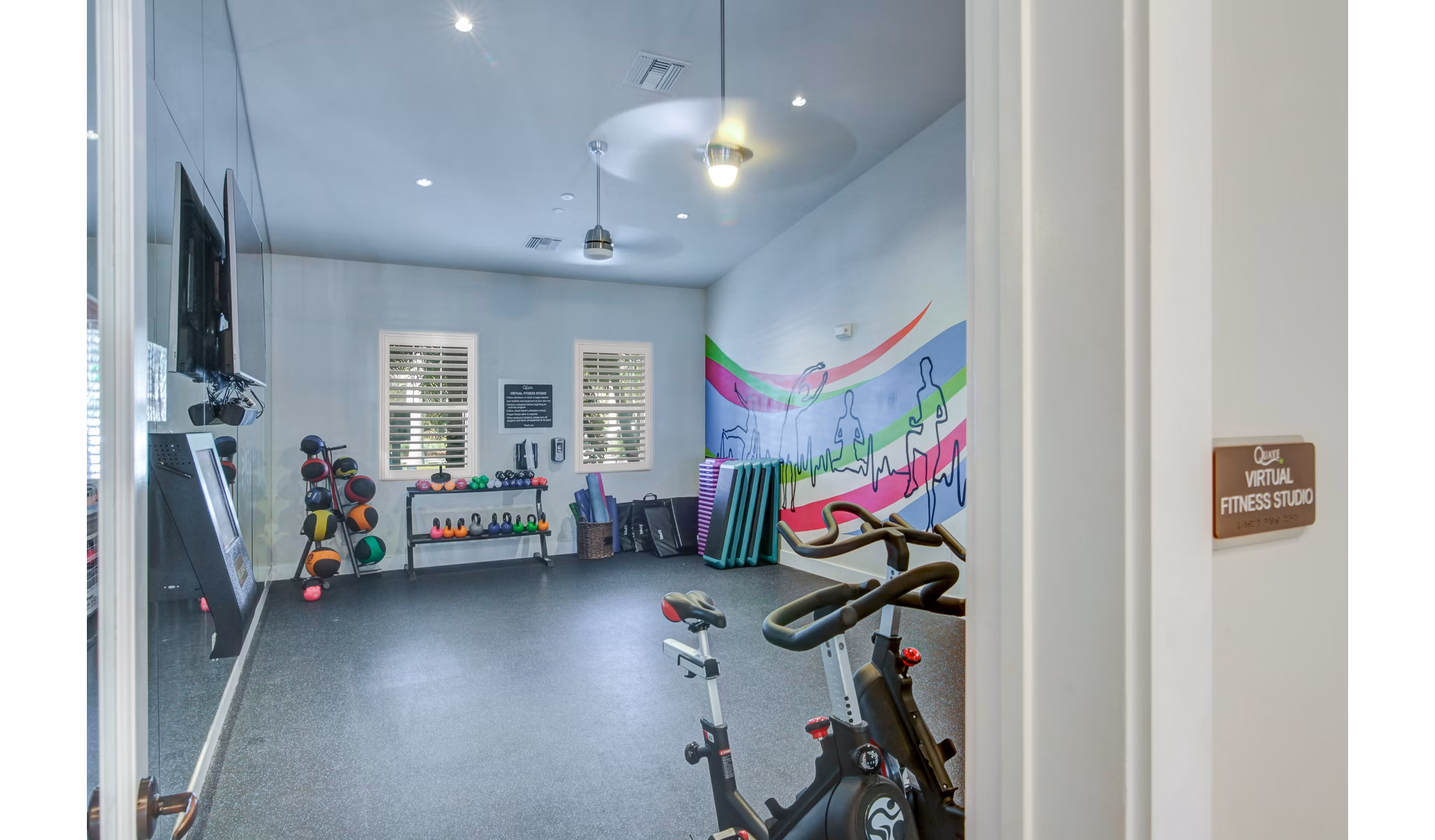 Yoga and spin studio at The Quaye in Palm Beach Gardens Apartments featuring fitness equipment and bright, airy space