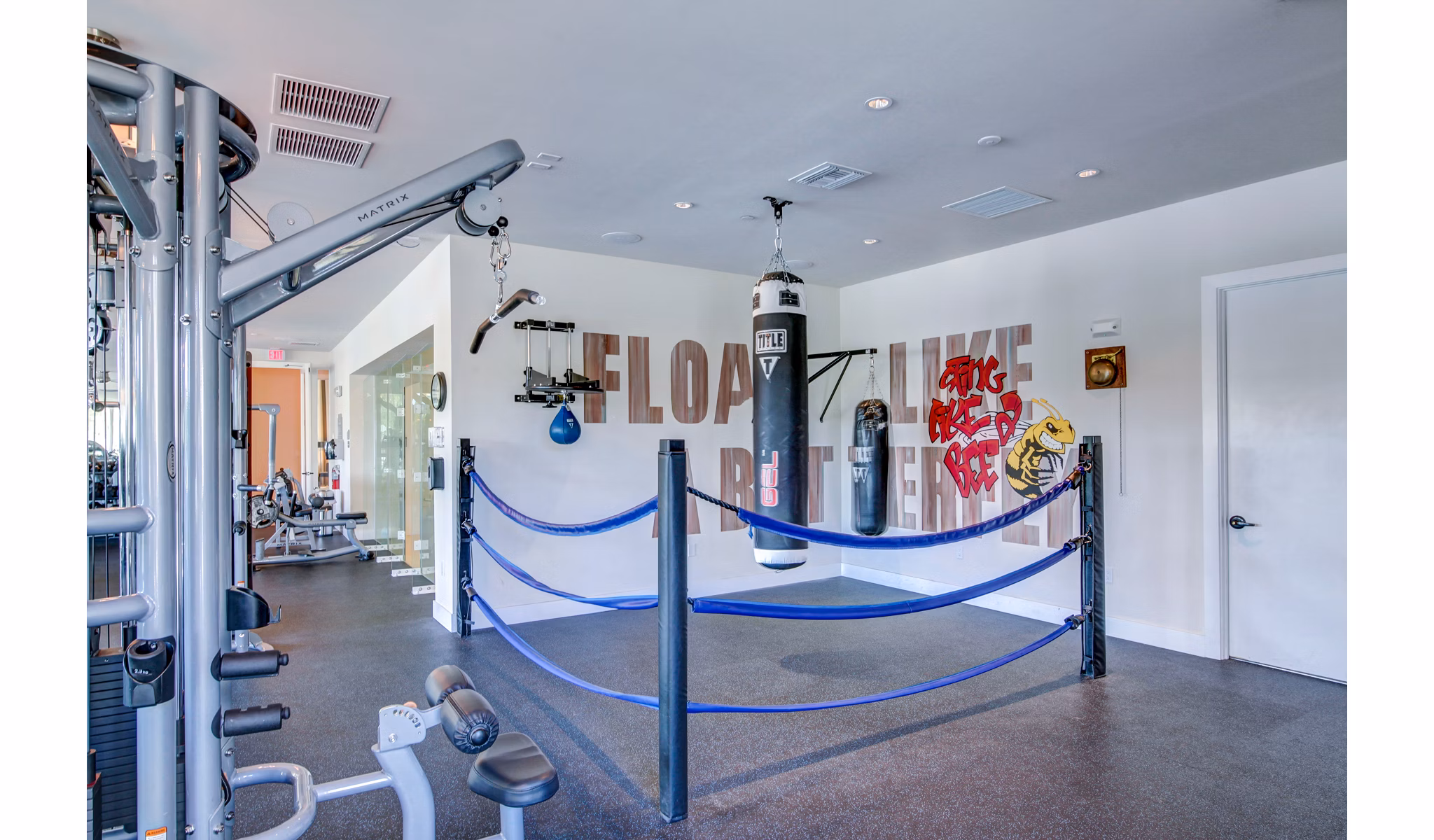 State-of-the-art fitness center at The Quaye at Palm Beach Gardens Apartments with modern equipment and spacious workout areas