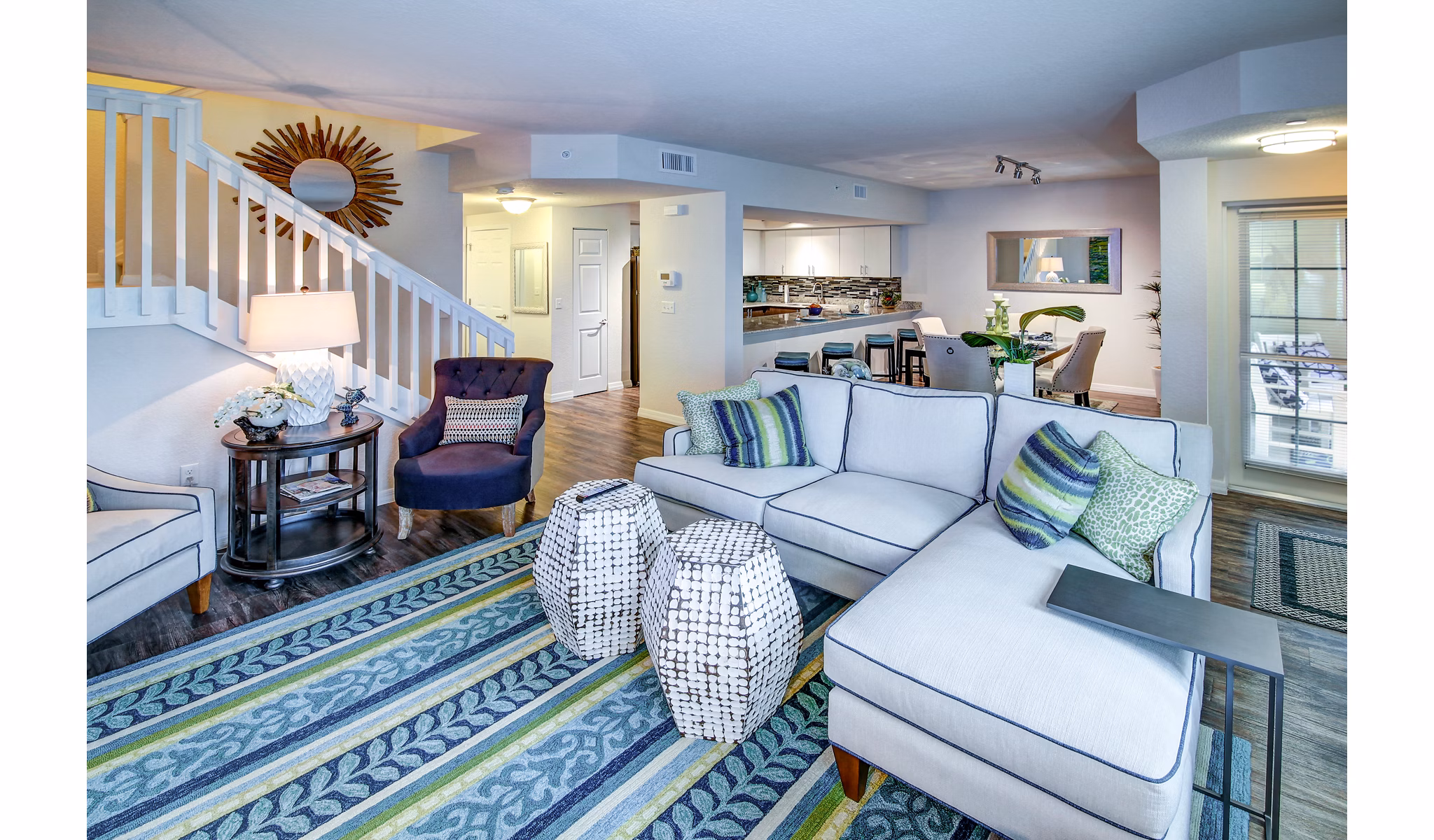 Bright living room with modern decor at The Quaye at Palm Beach Gardens Apartments