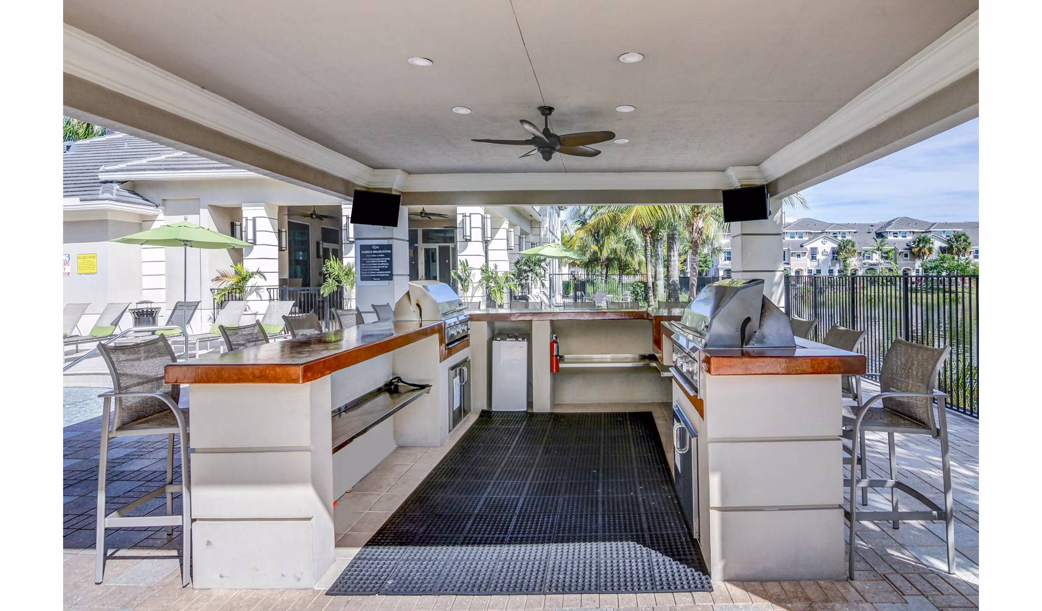 Outdoor grill area with modern amenities at The Quaye at Palm Beach Gardens Apartments, ideal for gatherings and relaxation