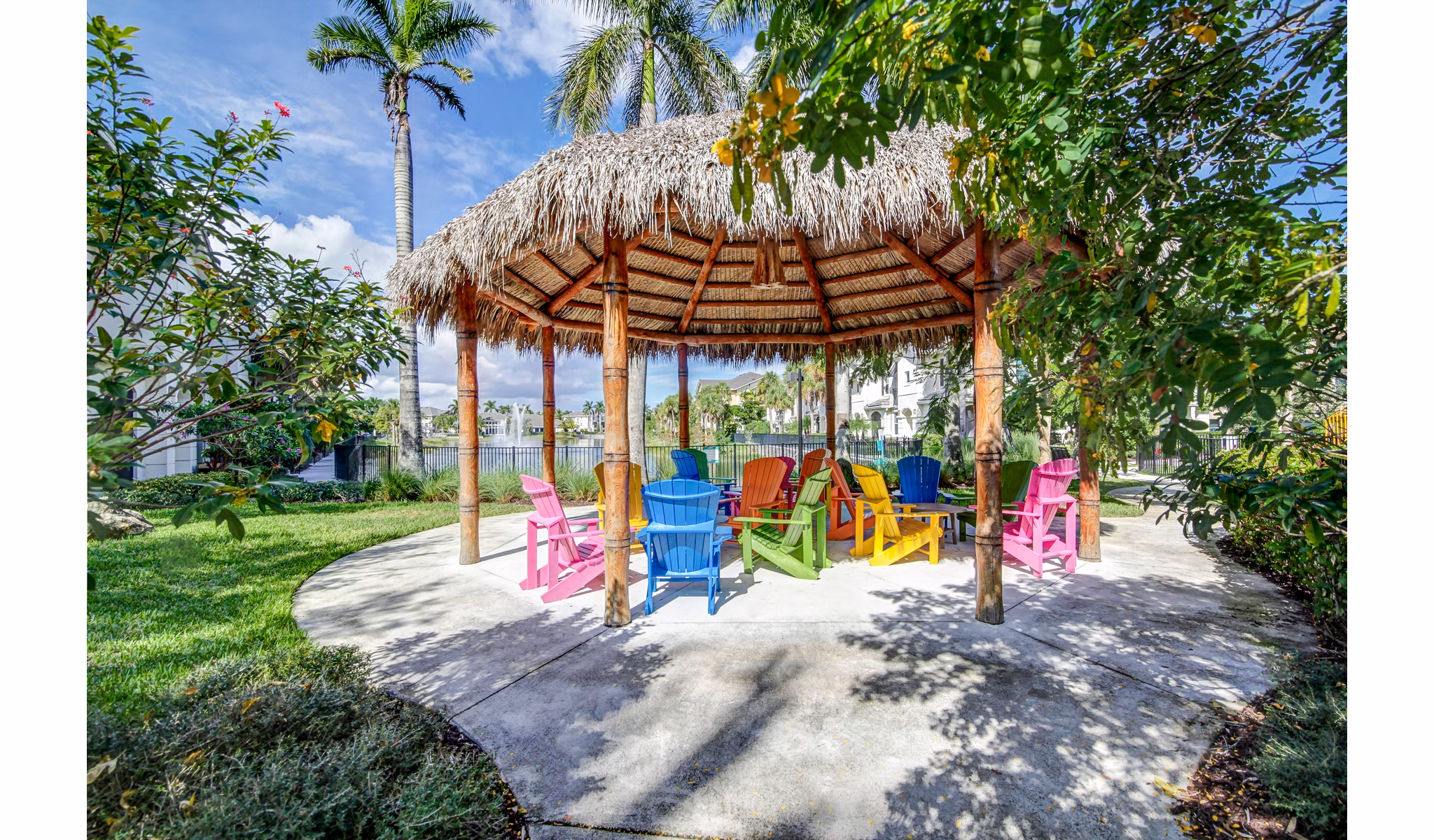 Elegant patio at The Quaye at Palm Beach Gardens Apartments featuring cozy seating and lush greenery