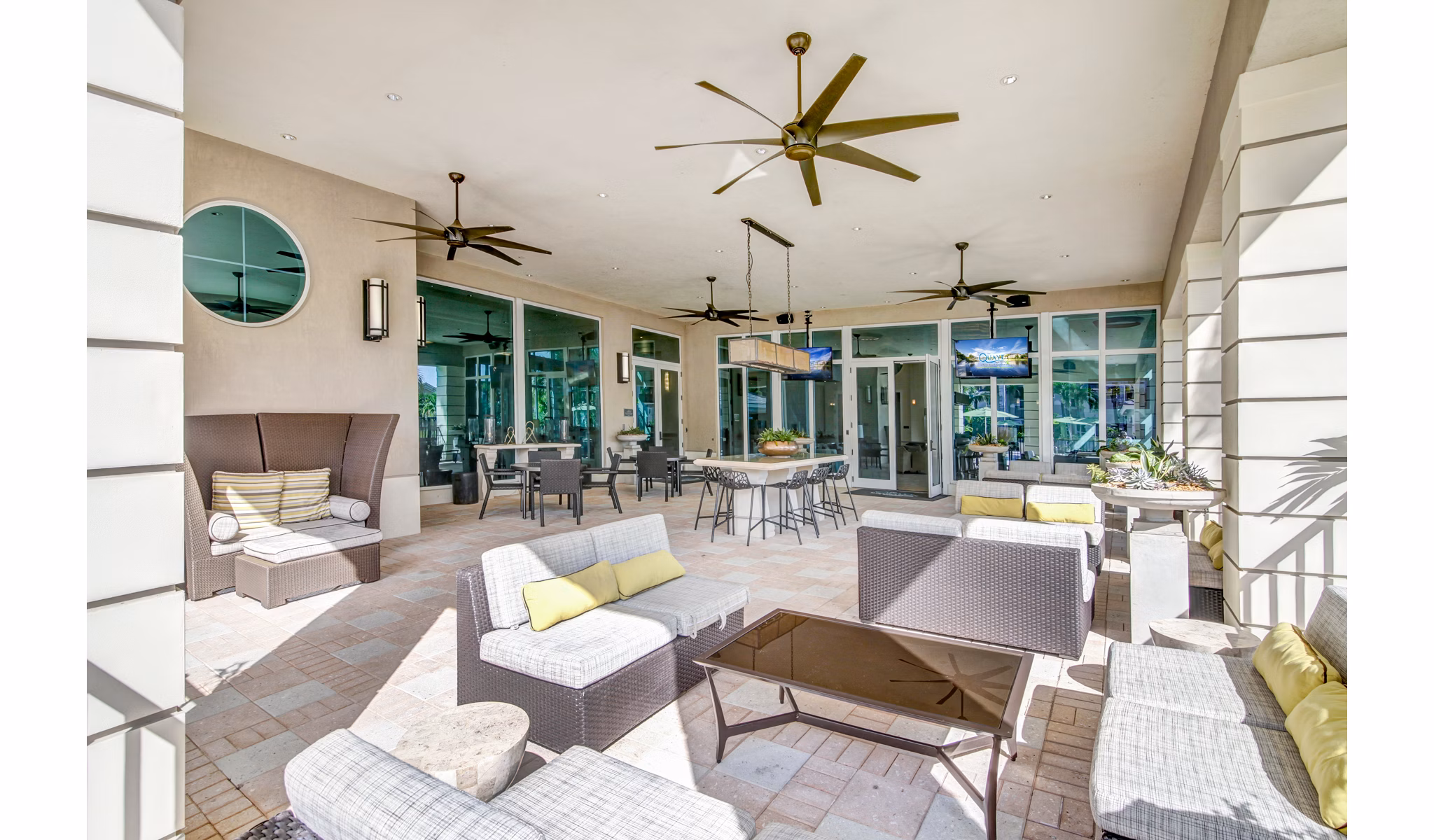 Outdoor patio with modern seating at The Quaye at Palm Beach Gardens Apartments, a luxury residence in serene surroundings
