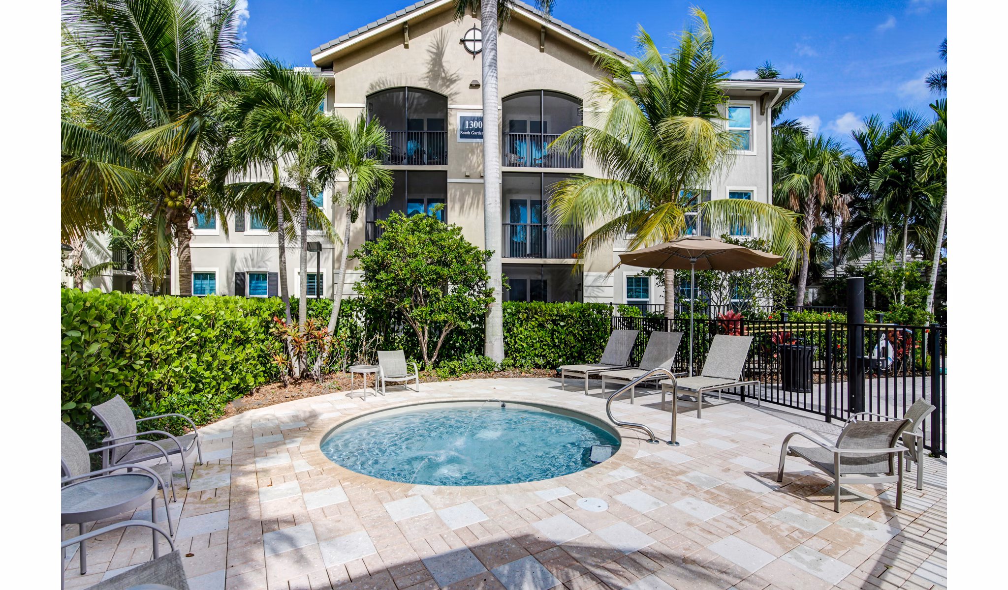 Relaxing hot tub at The Quaye at Palm Beach Gardens Apartments, offering luxury relaxation in a serene setting