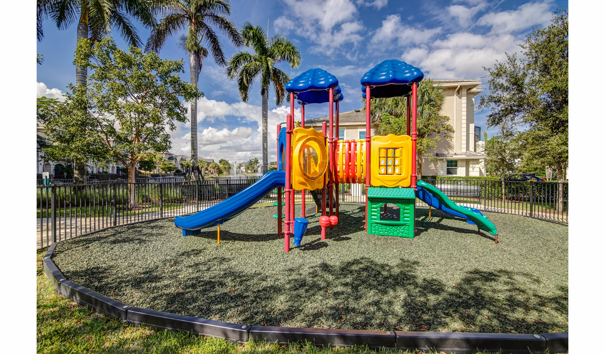 Playground with modern play structures at The Quaye at Palm Beach Gardens Apartments