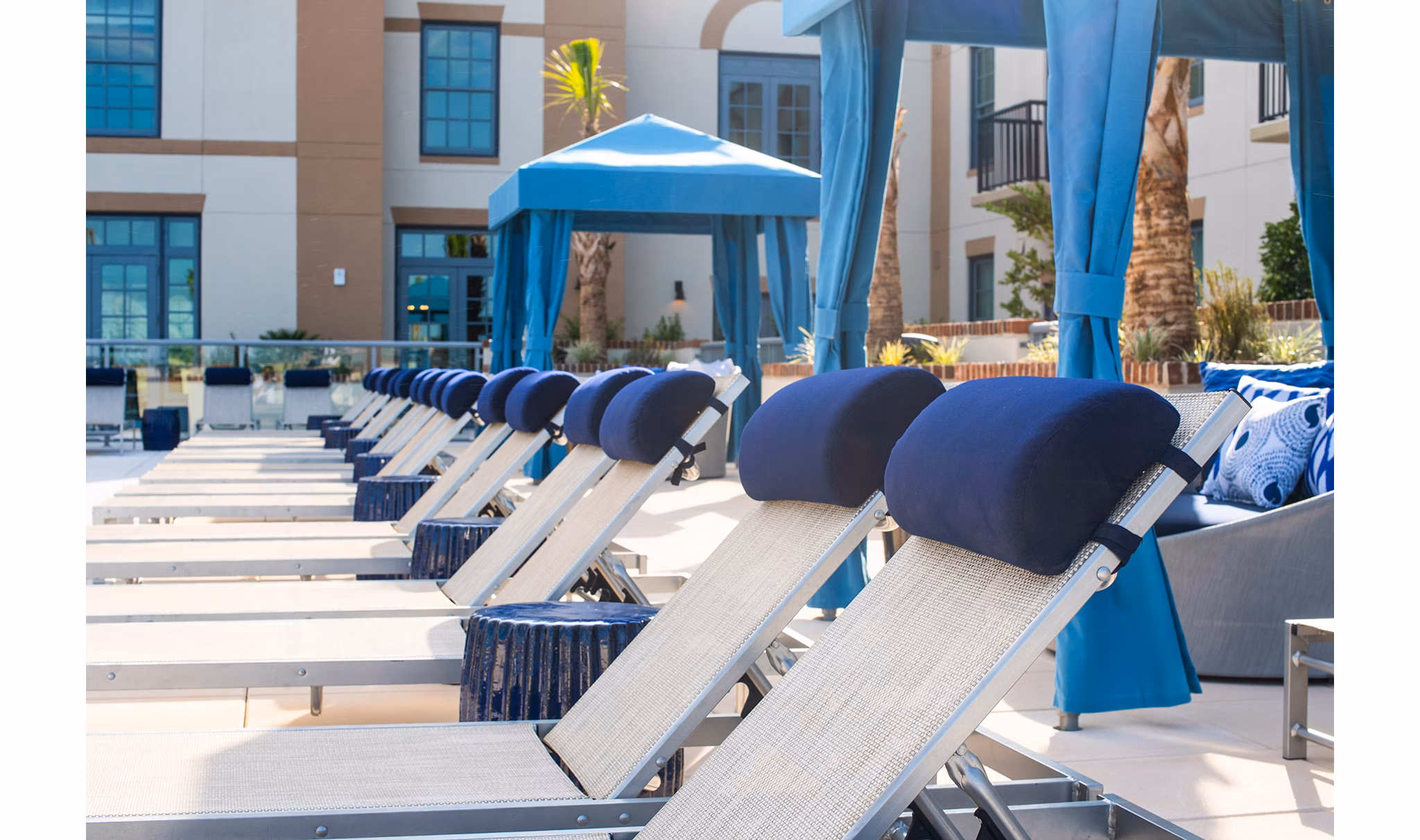 Stunning outdoor pool with luxurious seating at The Guild Apartments
