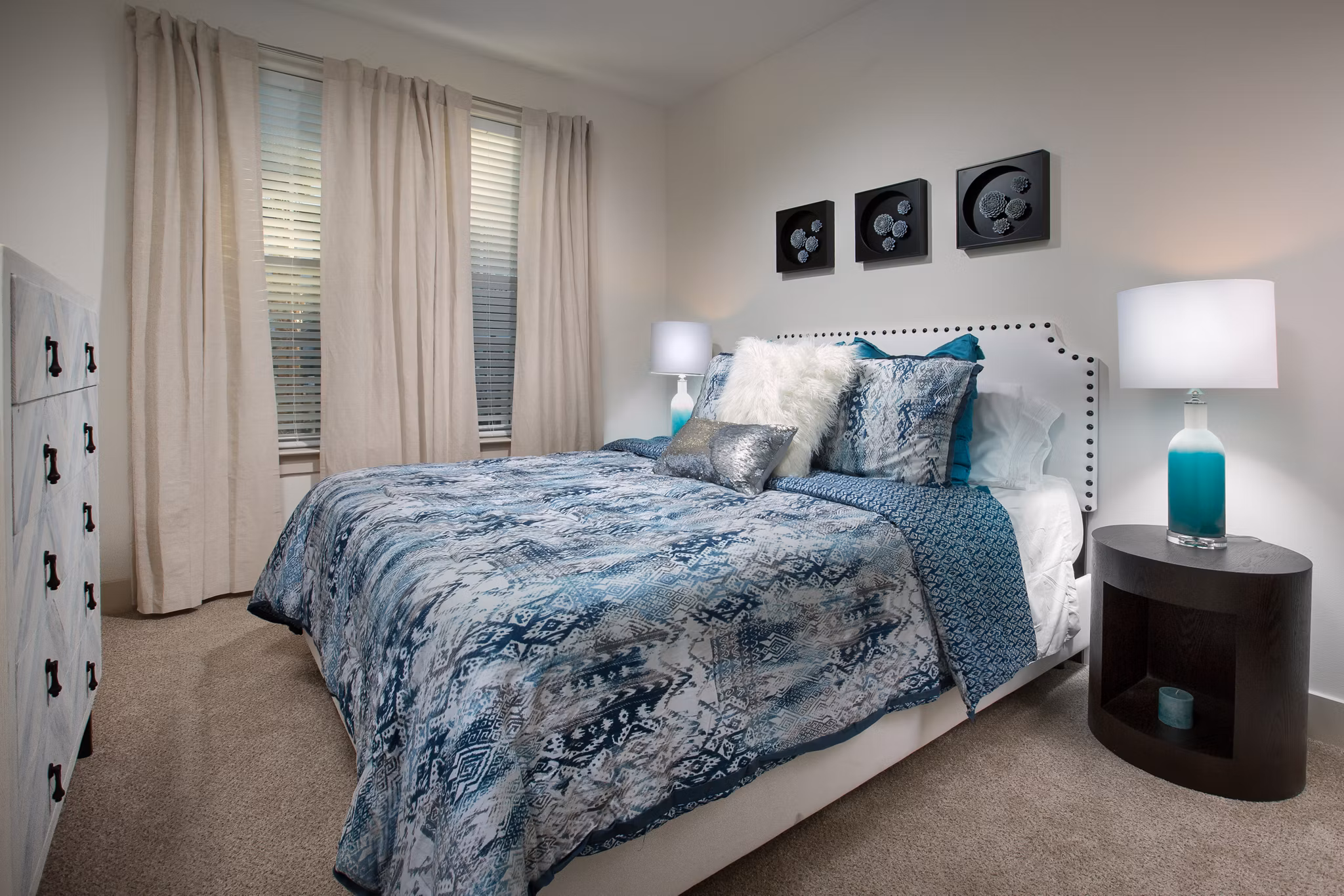Cozy bedroom with ocean-inspired decor at Sea Glass Apartments