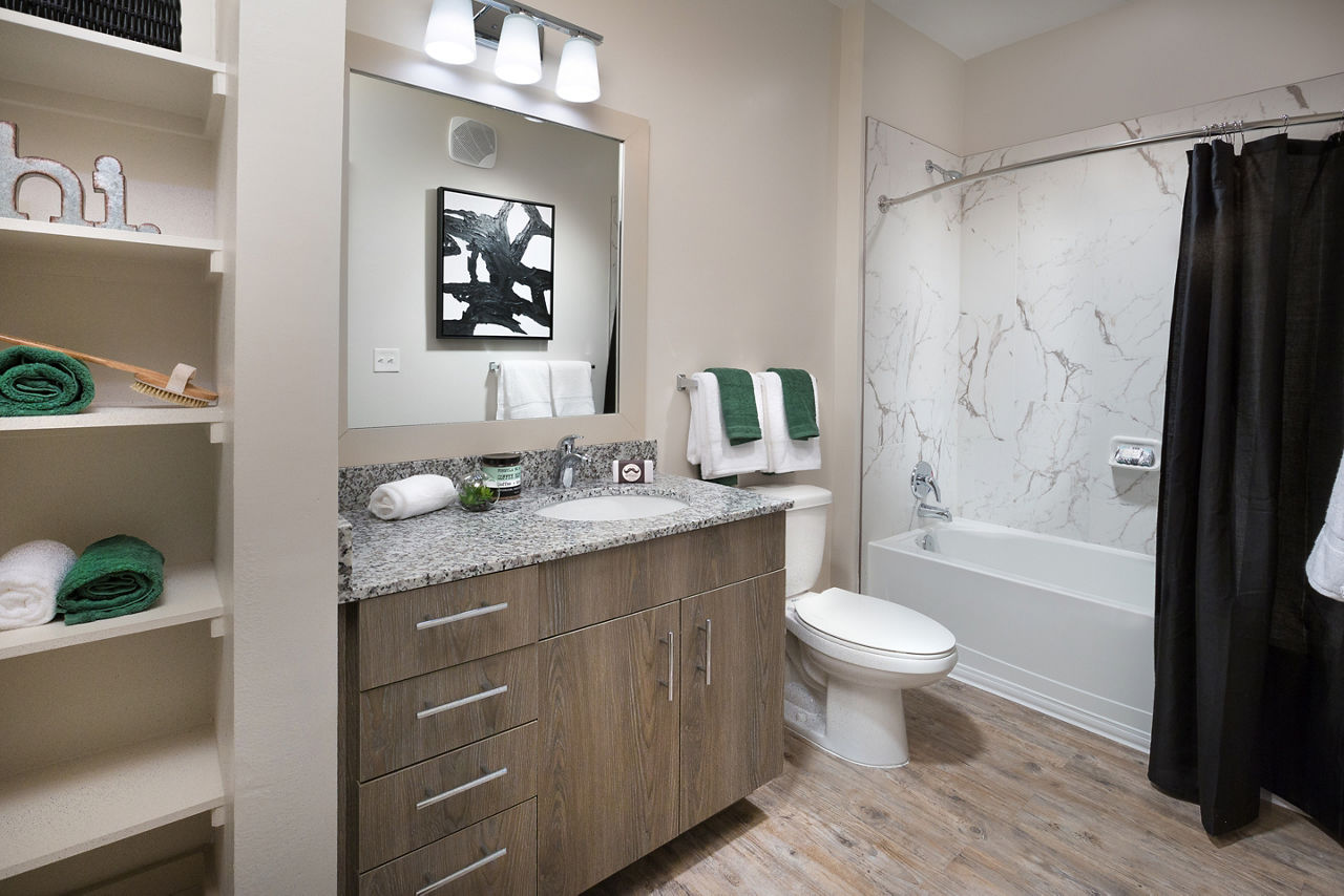 Bathroom featuring elegant fixtures and marble countertops in Sea Glass Apartments