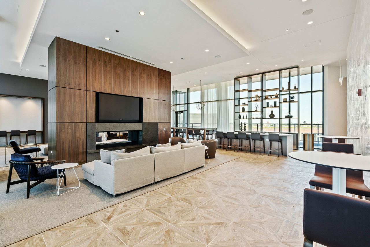 Modern clubhouse with plush seating and art installations at Elevate Apartments, perfect for social gatherings and relaxation