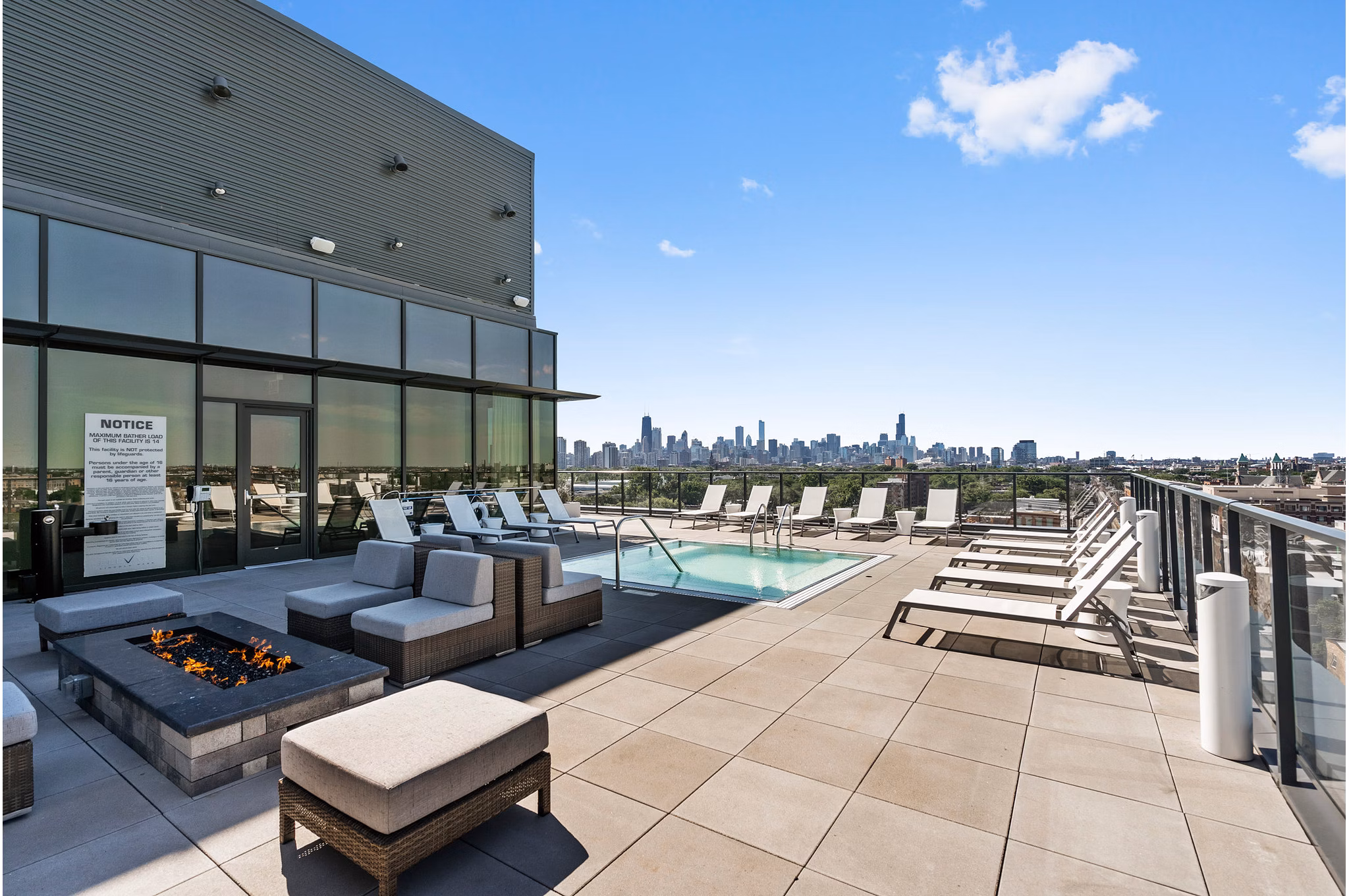 Modern outdoor pool area with lounge chairs at Elevate Apartments, a luxury community offering relaxation and style