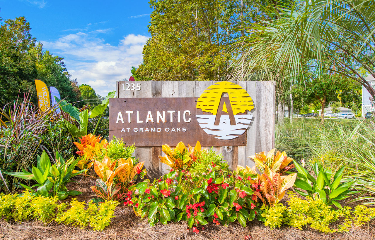Atlantic at Grand Oaks: Elegant apartment signage showcasing luxury residences in a serene setting