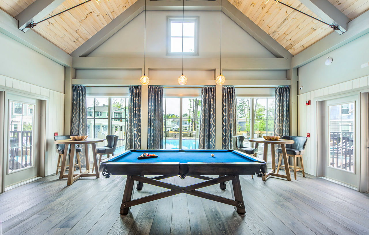 Vibrant game room with pool table and lounge seating at Atlantic at Grand Oaks Apartments