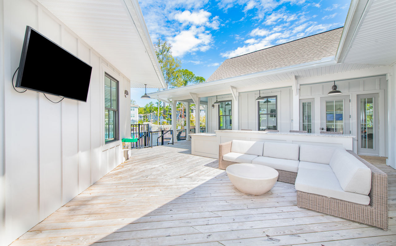 Cozy outdoor patio with modern seating at Atlantic at Grand Oaks Apartments, ideal for relaxation and socializing