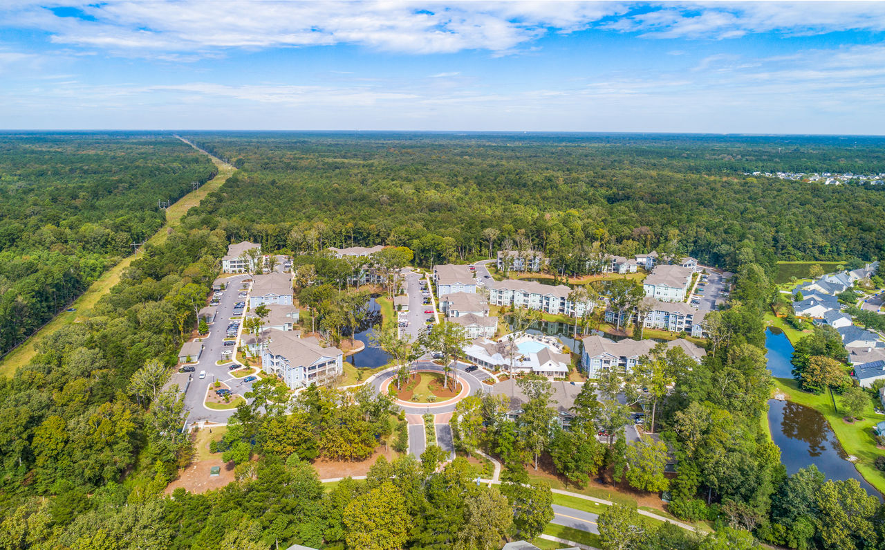 Atlantic at Grand Oaks: Stunning view of luxury apartments in a serene setting with spacious balconies