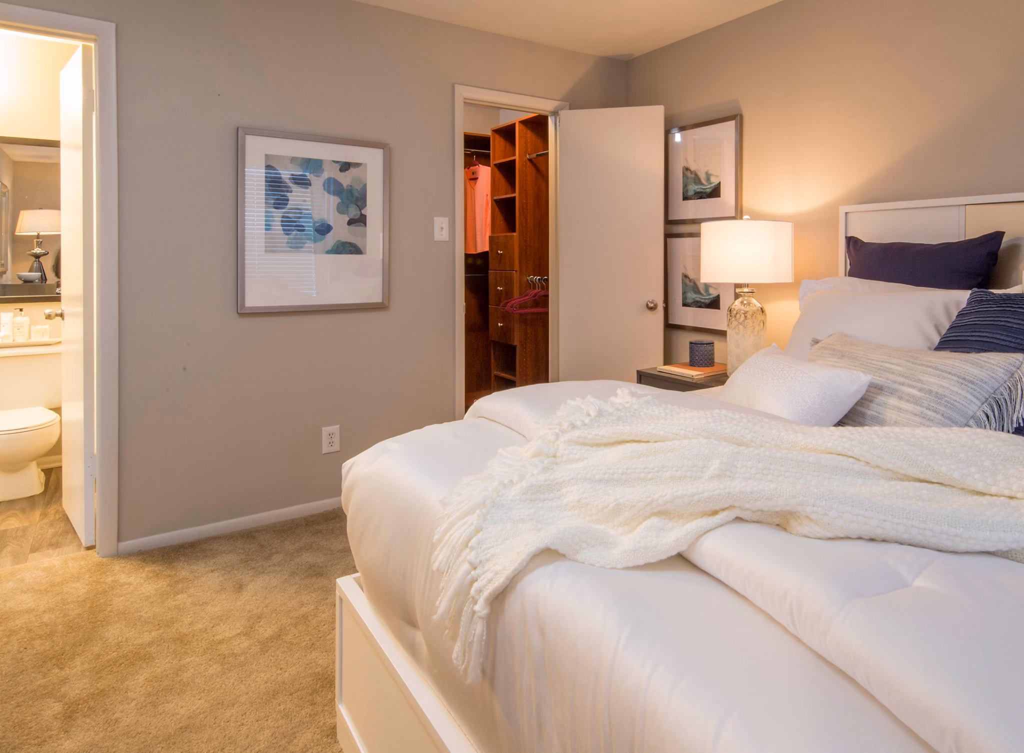 Bedroom with plush carpeting and scenic window views at Lakeside Mill Apartments